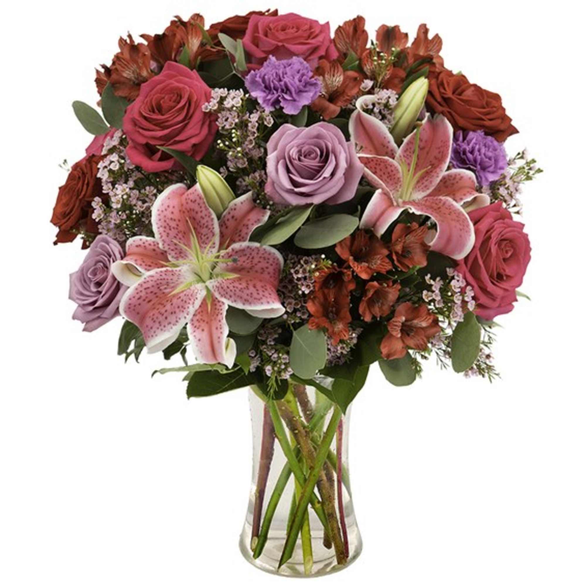 Mixed bouquet of pink roses and lilies in a clear glass vase
