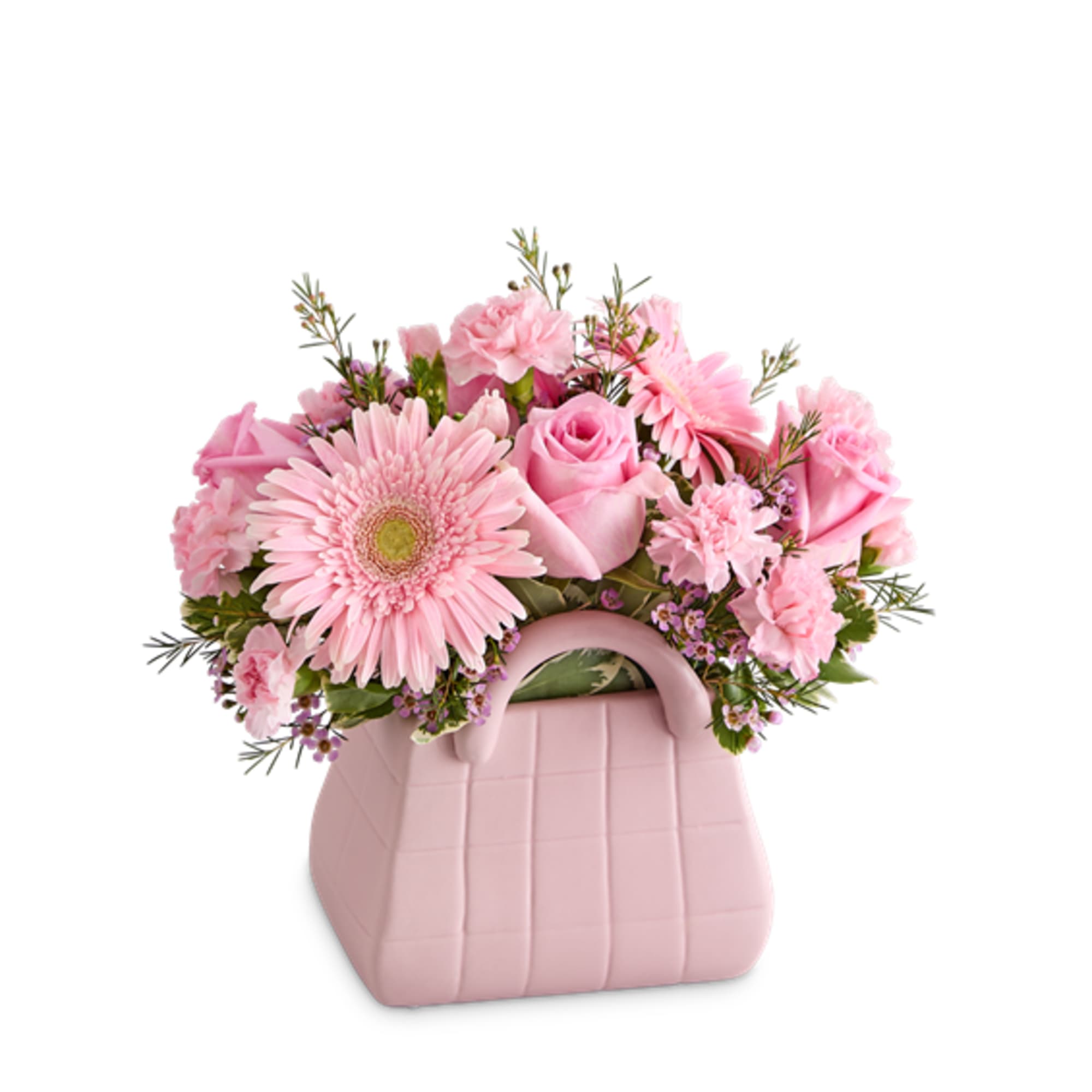 Pink flower arrangement in a blush handbag-shaped container