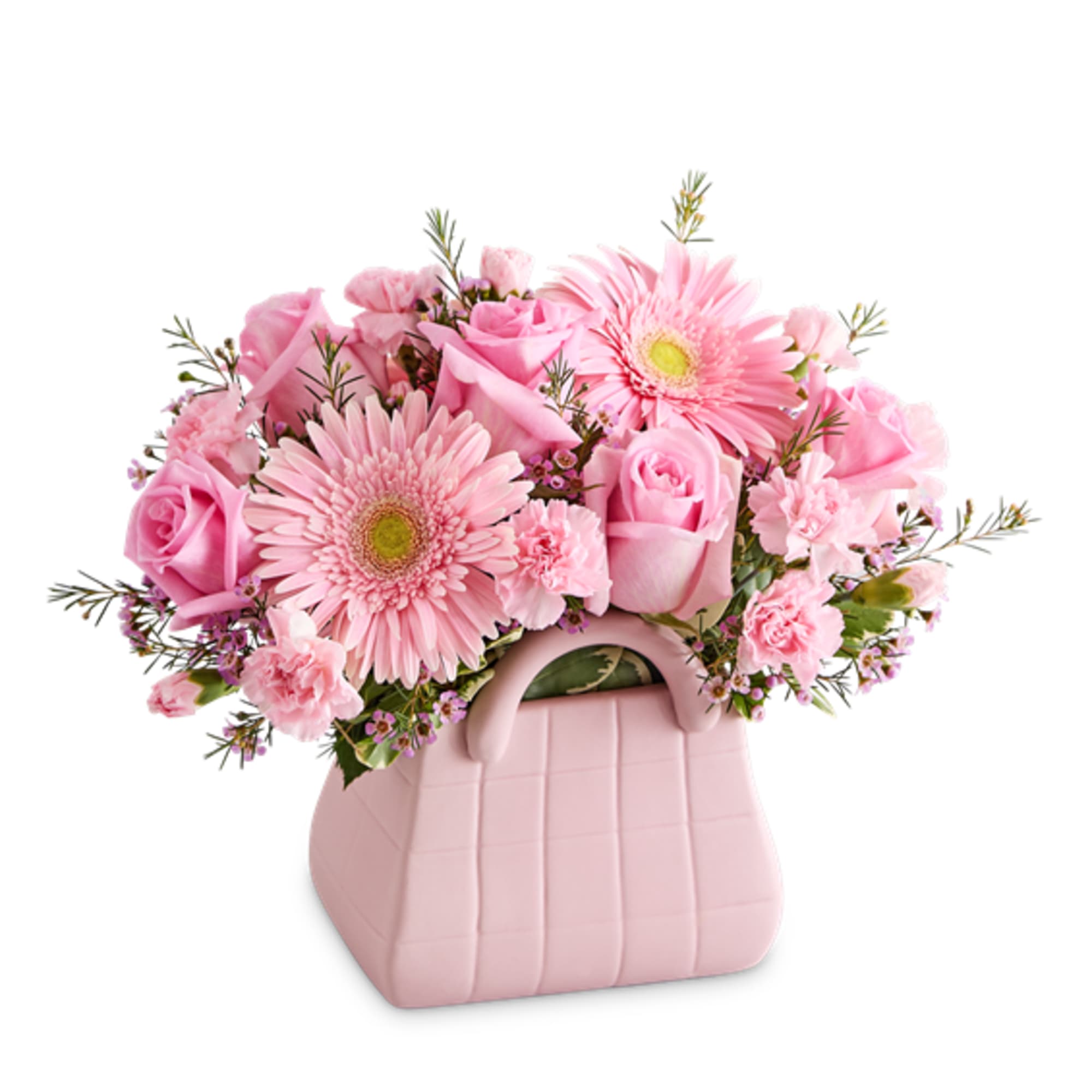 Pink roses and gerbera daisies in a pink handbag-shaped container
