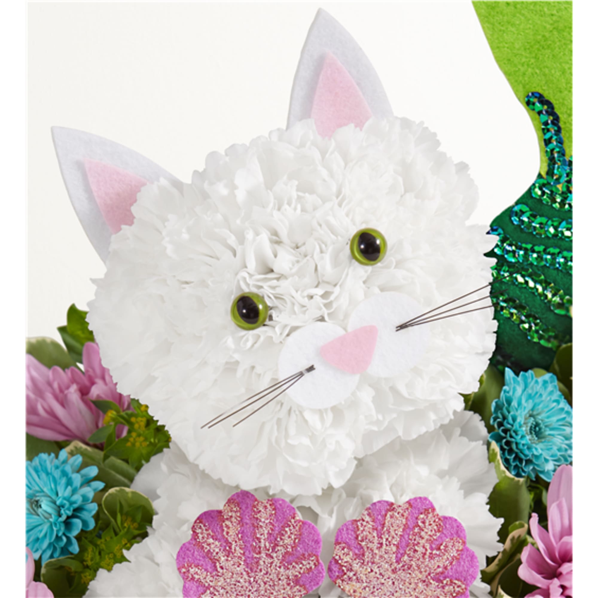 White cat-shaped floral arrangement with pink ears and a green sequined accent