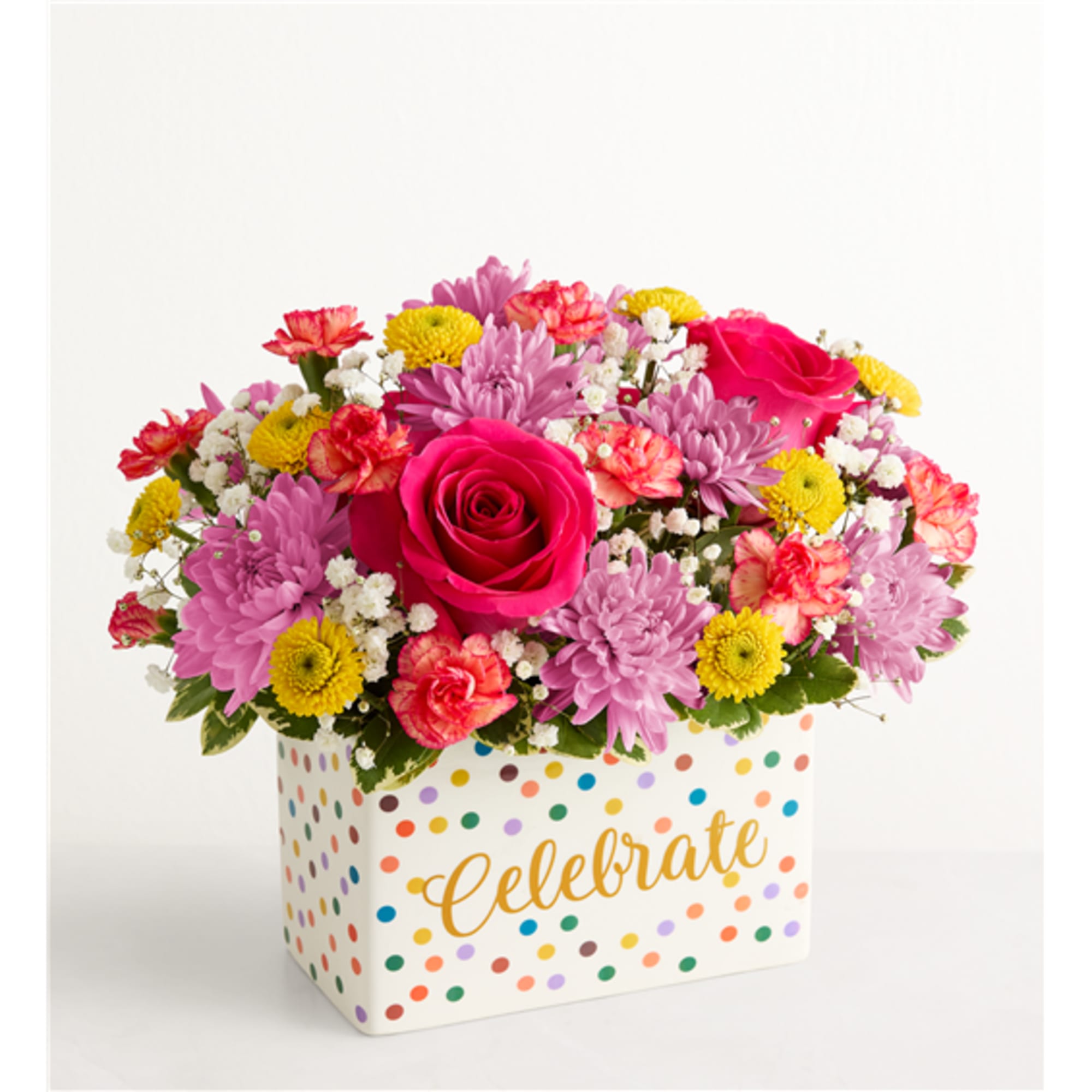 Mixed pink, purple, and yellow flowers in a polka-dot box with "Celebrate" text