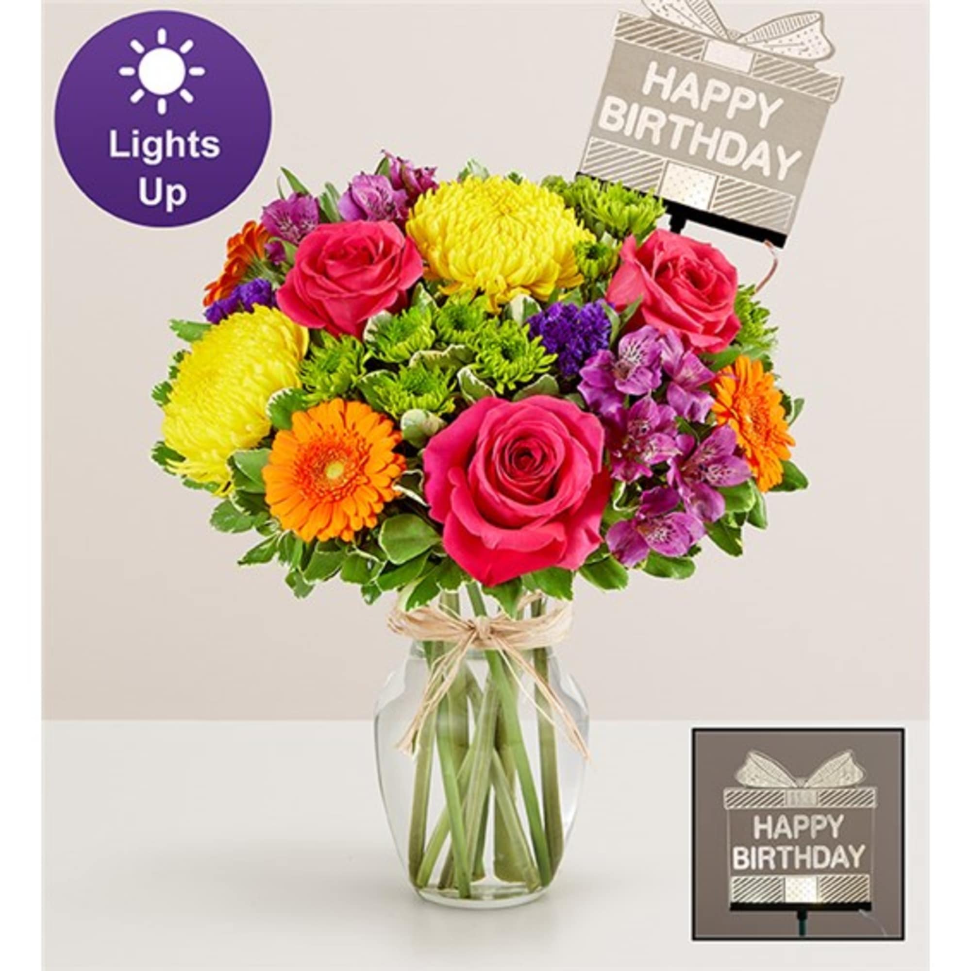 Mixed bouquet in a glass vase with a birthday card topper