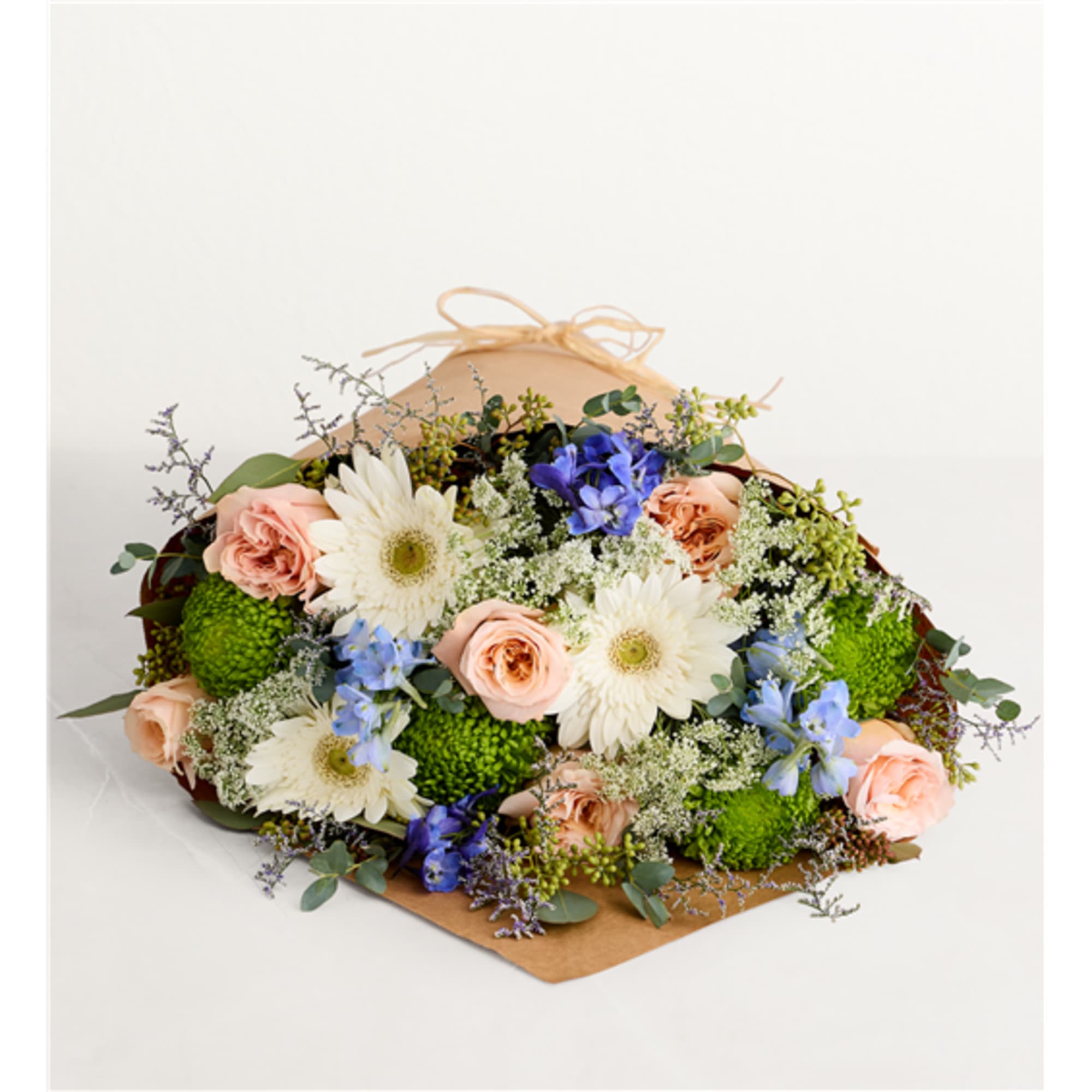 Mixed bouquet of peach roses, white daisies, and blue flowers in kraft wrap