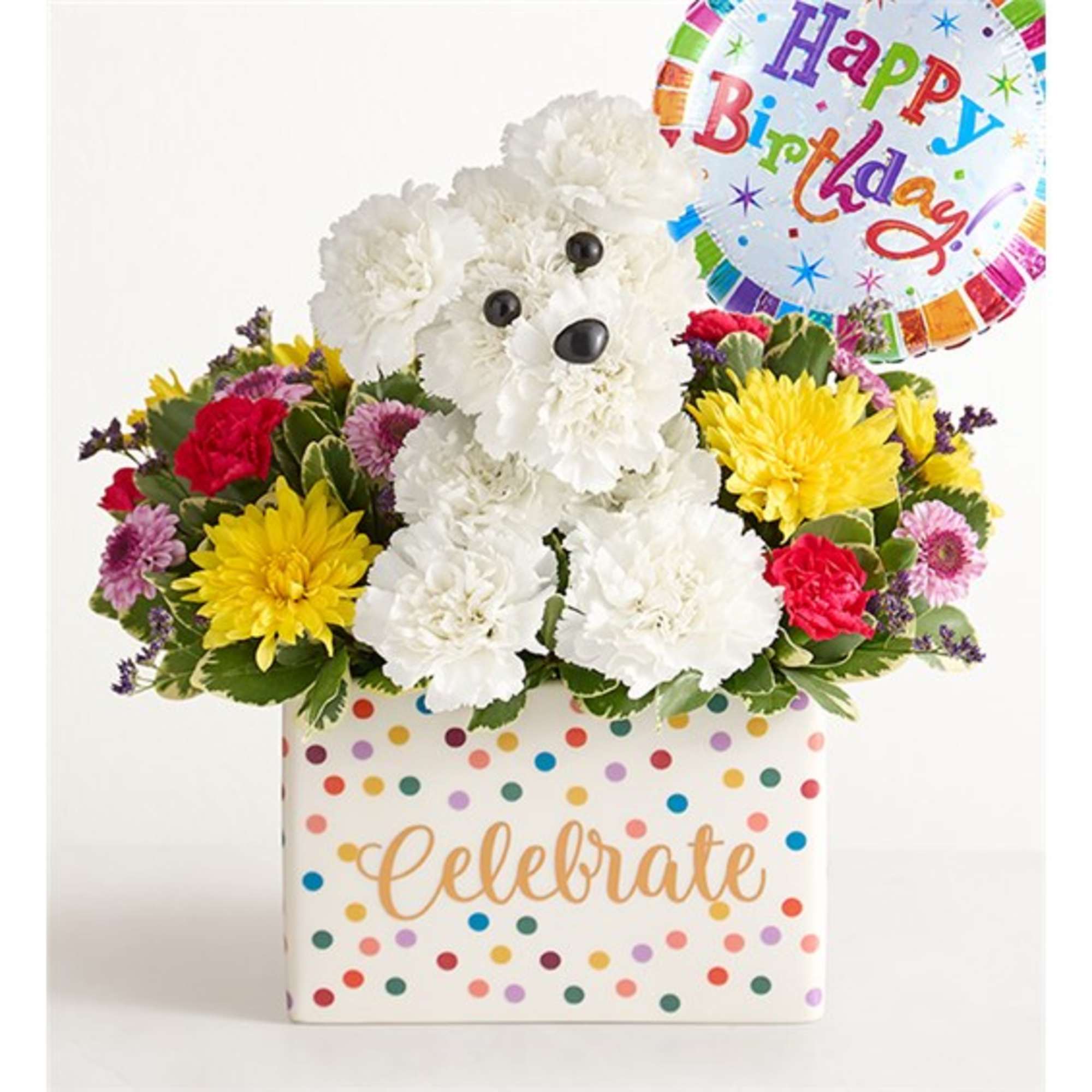 White teddy bear in a flower box with colorful blooms and a birthday balloon