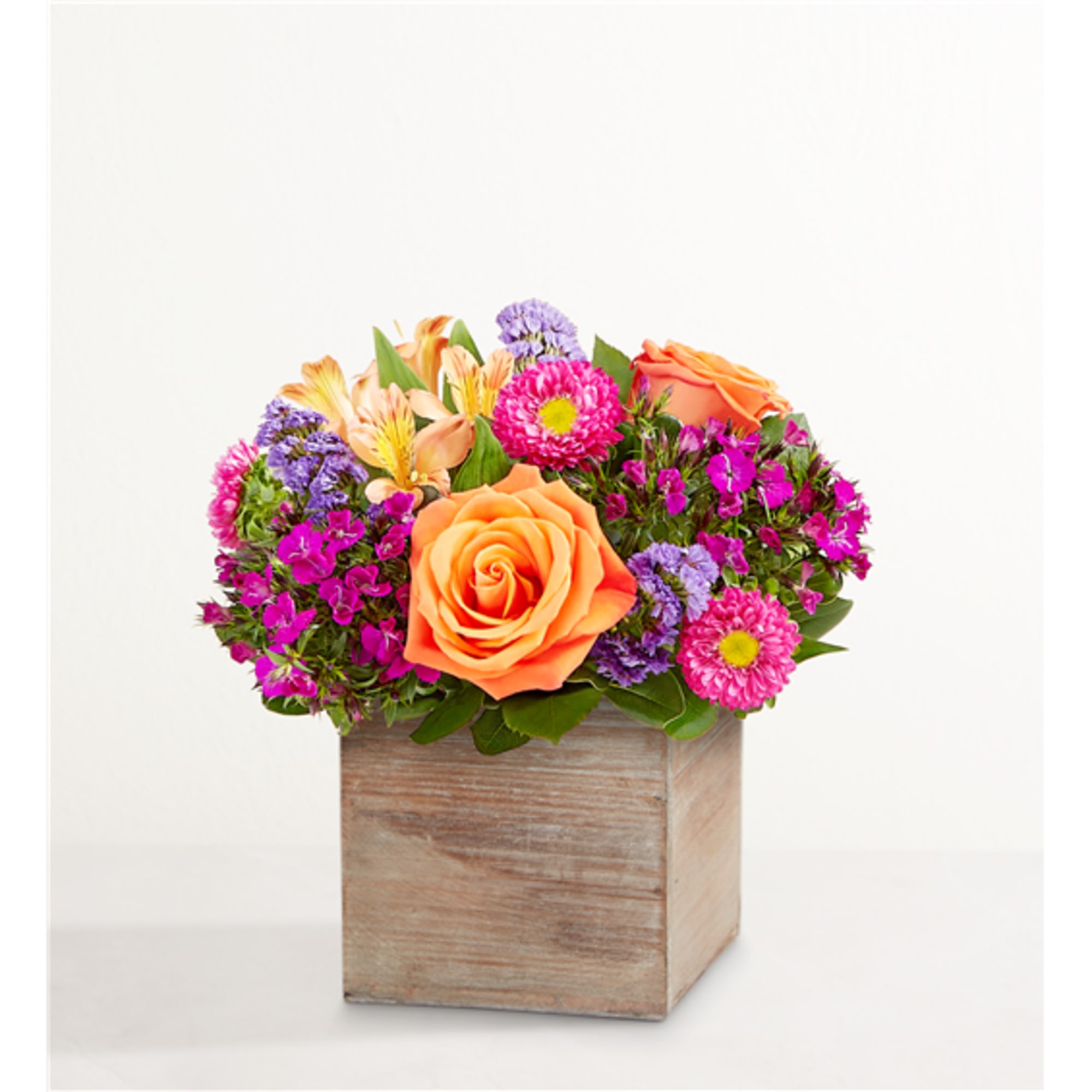 Mixed bouquet with orange roses in a wooden box