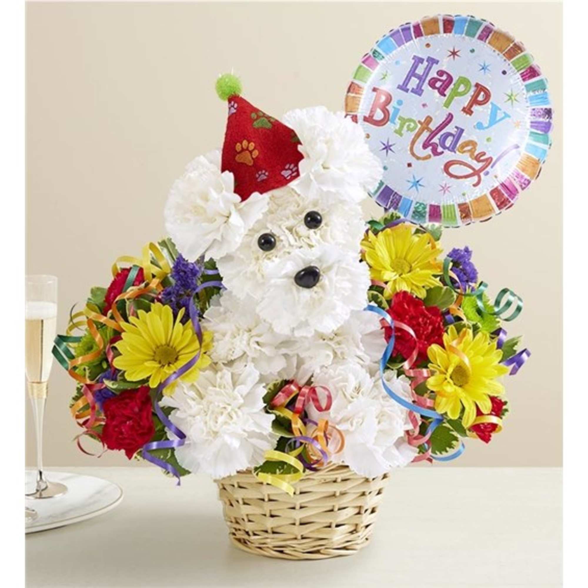 White flower dog arrangement in a basket with a birthday balloon