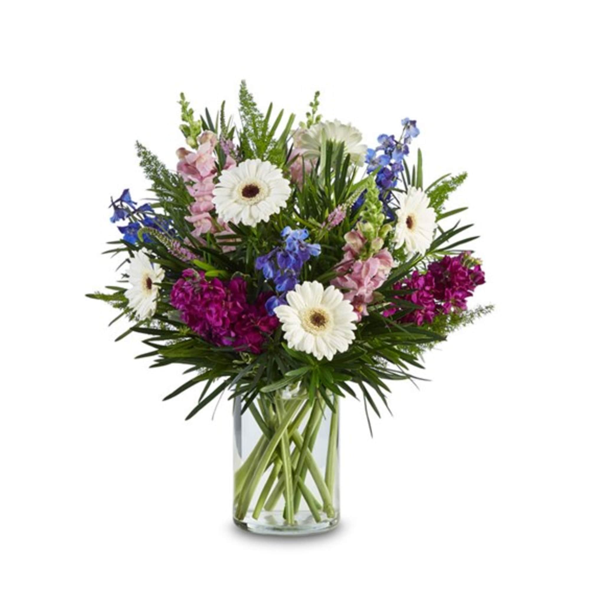 Mixed bouquet of white daisies, blue and pink flowers in a clear glass vase