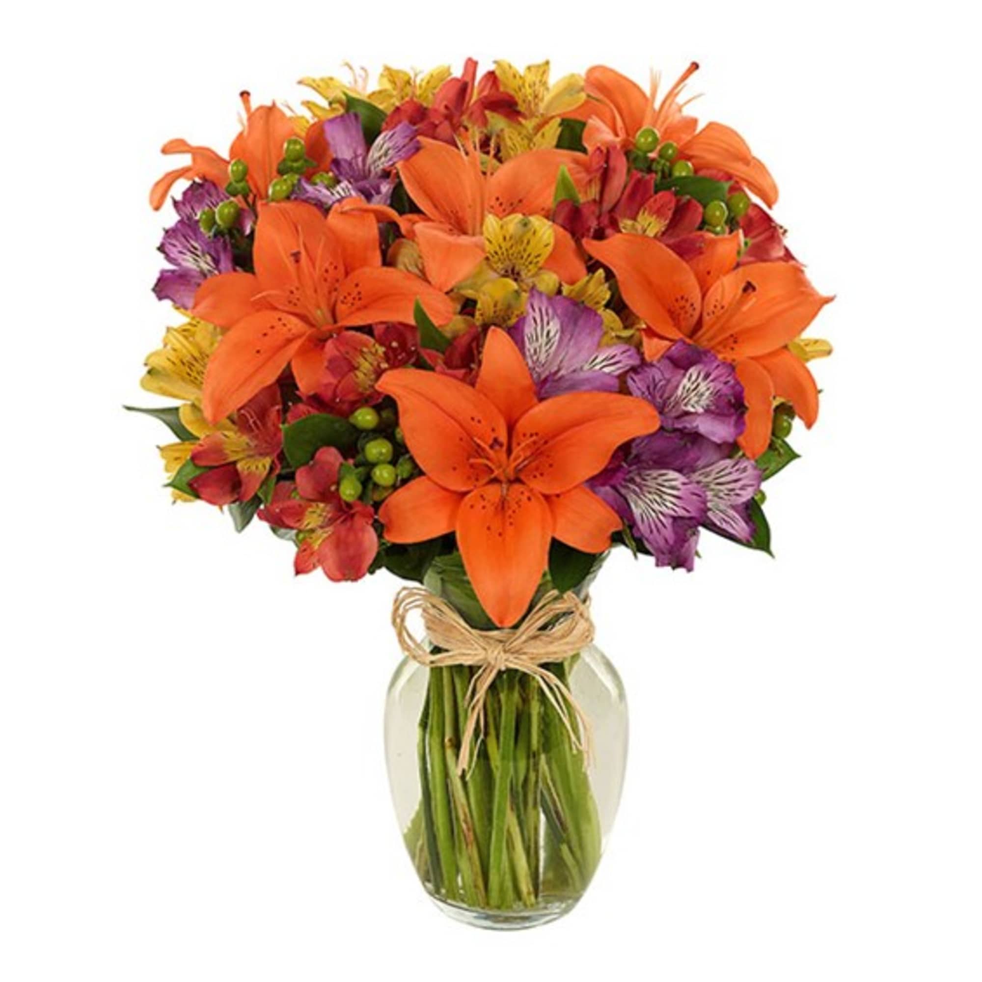 Orange lilies and mixed flowers in a glass vase with a raffia bow
