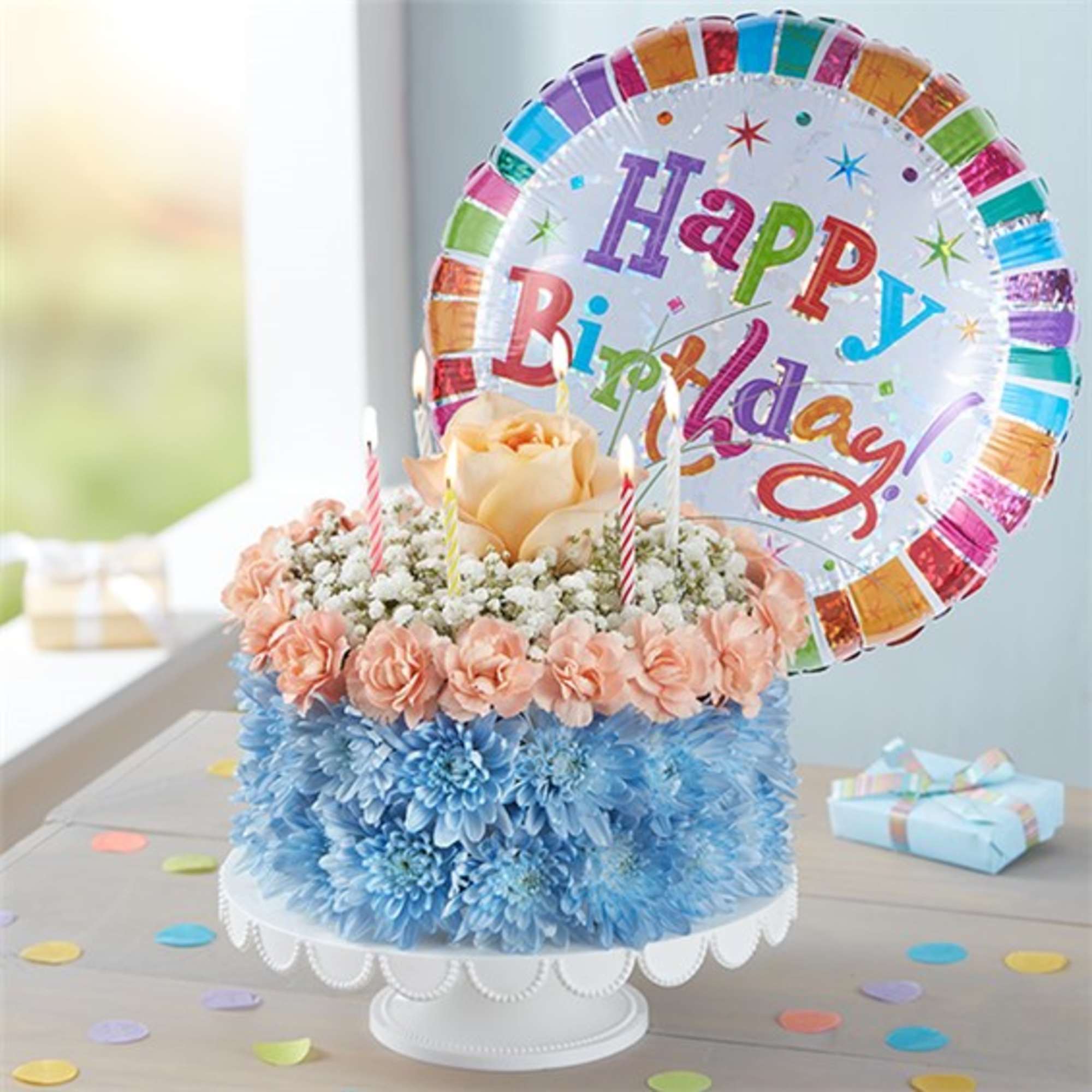 Birthday floral cake with a balloon and pastel flowers