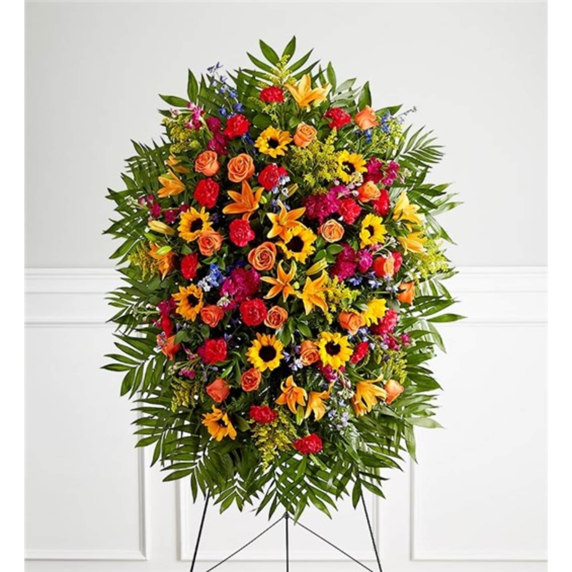 Standing floral spray with sunflowers, roses, lilies, and carnations
