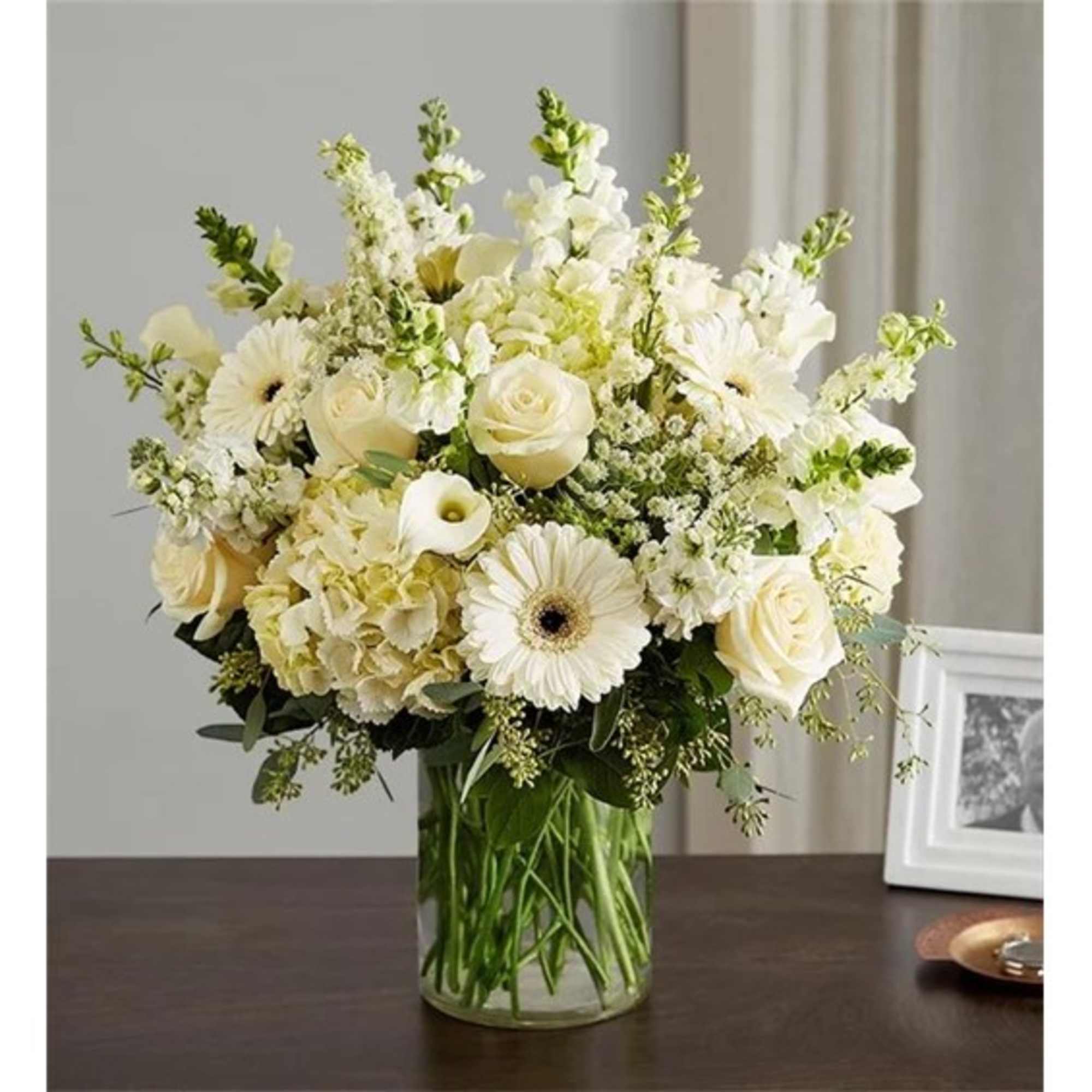 Cream and white bouquet in a clear glass vase