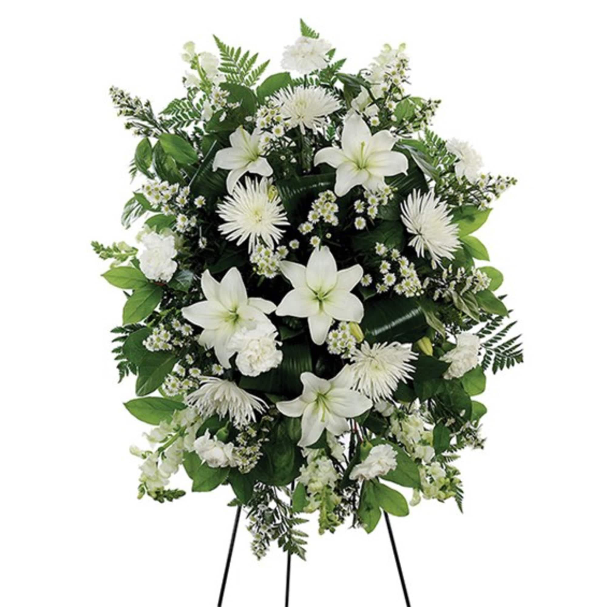 White floral standing spray on a black easel