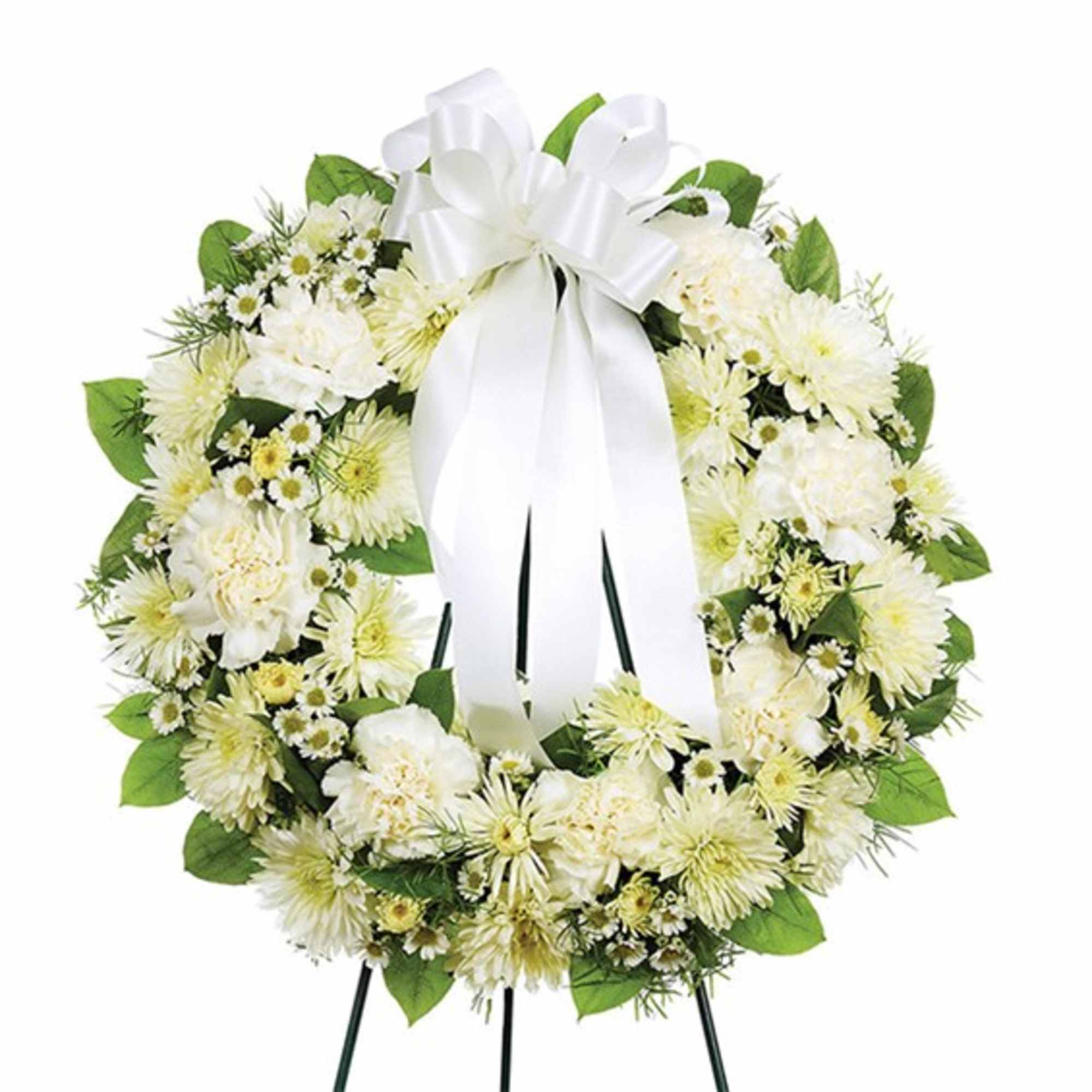White floral wreath with a large white ribbon bow on an easel