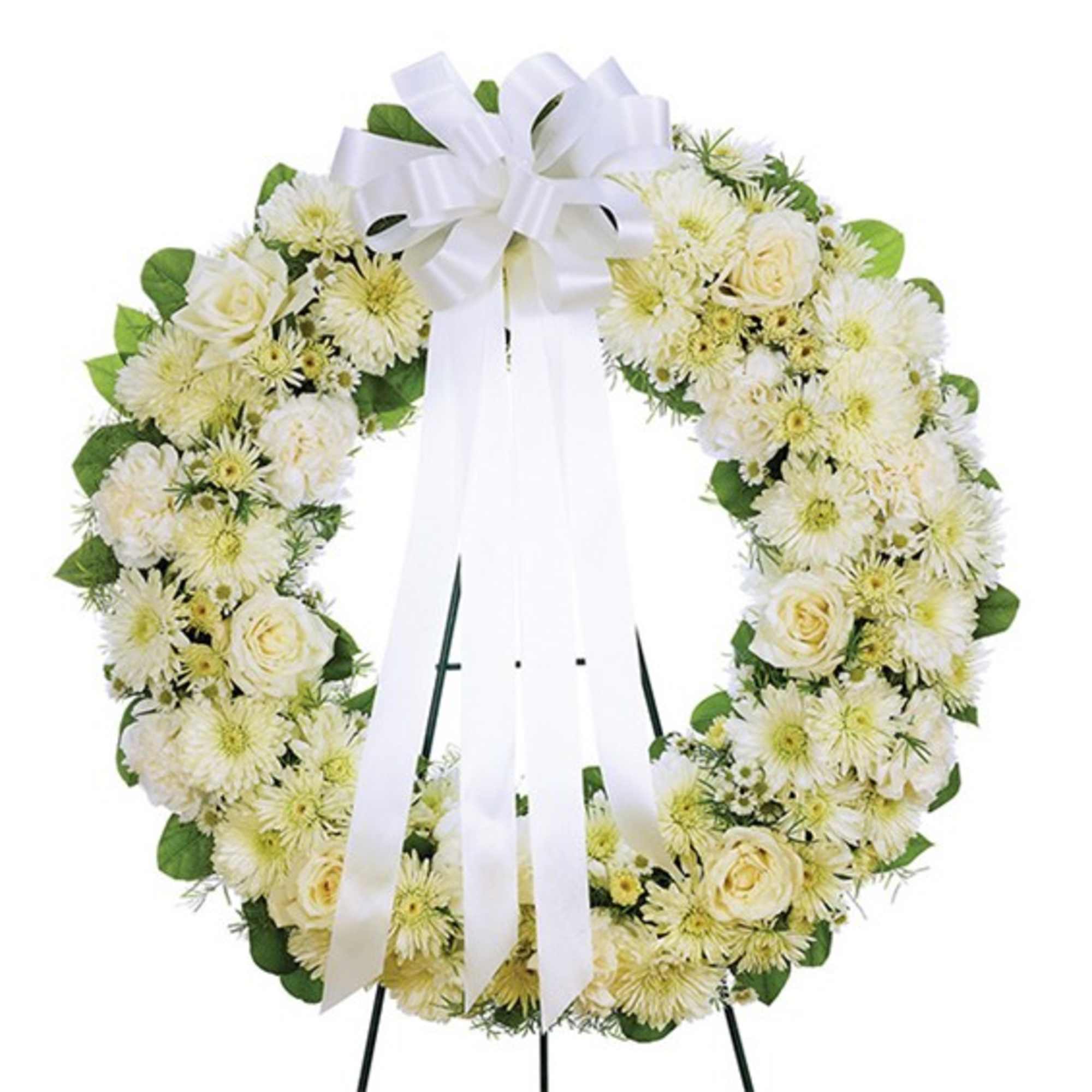 White floral wreath with a large ribbon bow on a stand