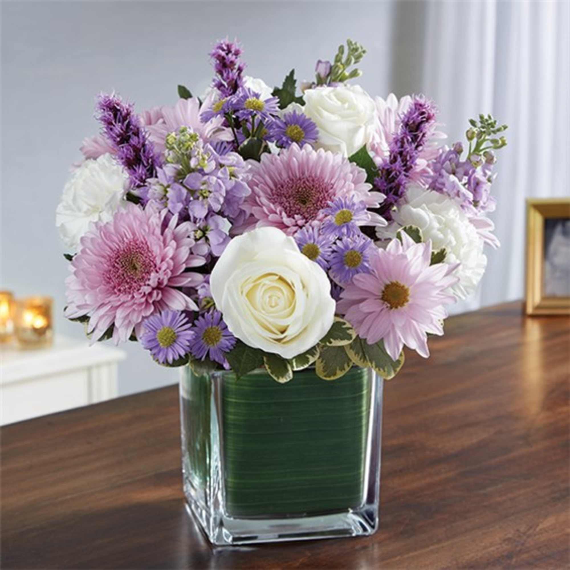 Lavender and white mixed bouquet in a square glass vase