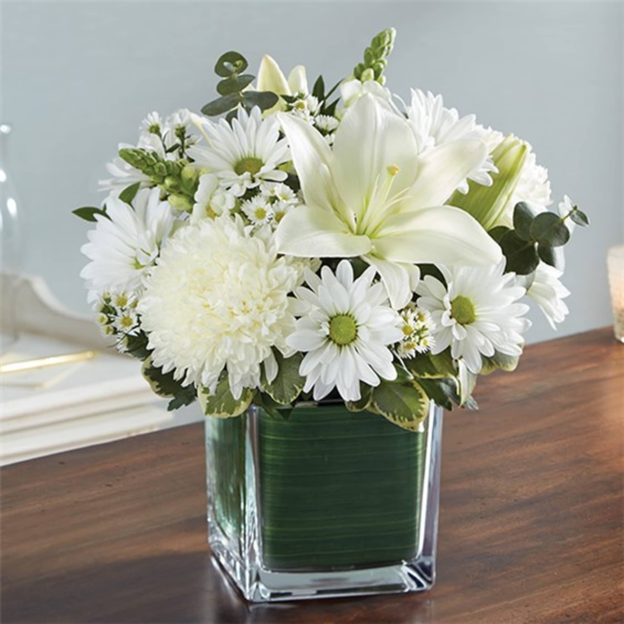 White flowers arranged in a square glass vase