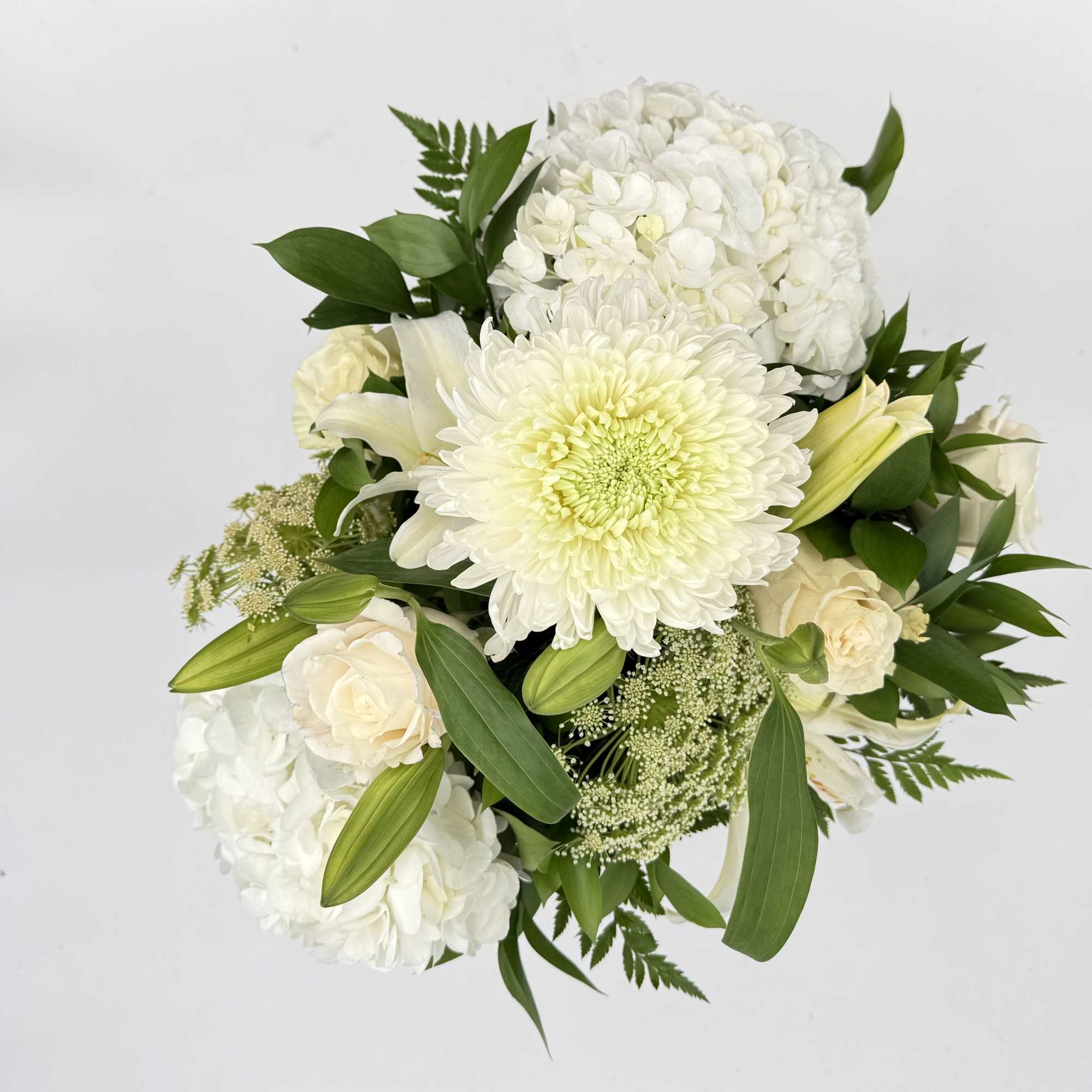 A quiet, composed centerpiece built around a dense cluster of white hydrangeas, photo 2 of 2