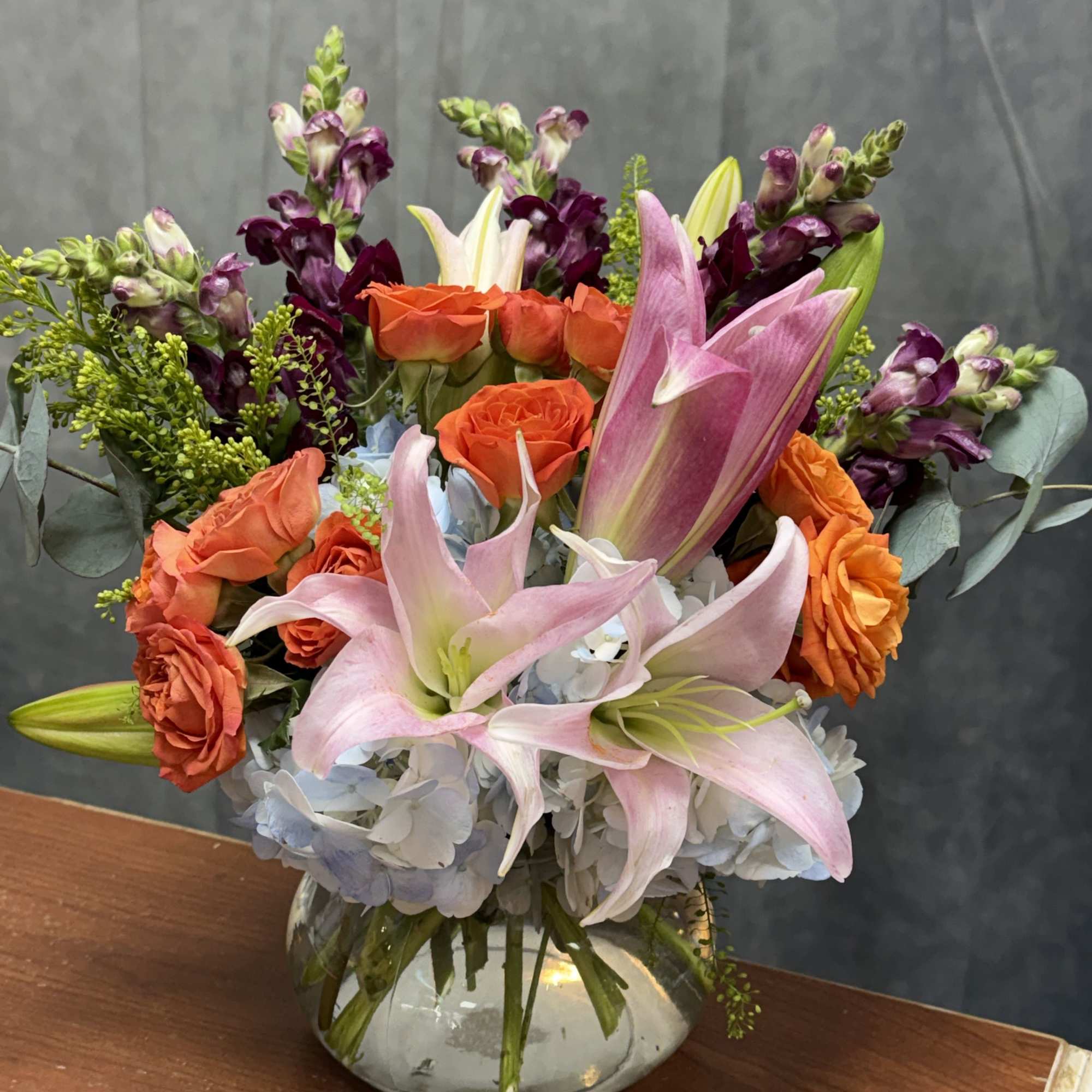 Flamingo Sunset is a vibrant floral arrangement bursting with warmth and elegance.