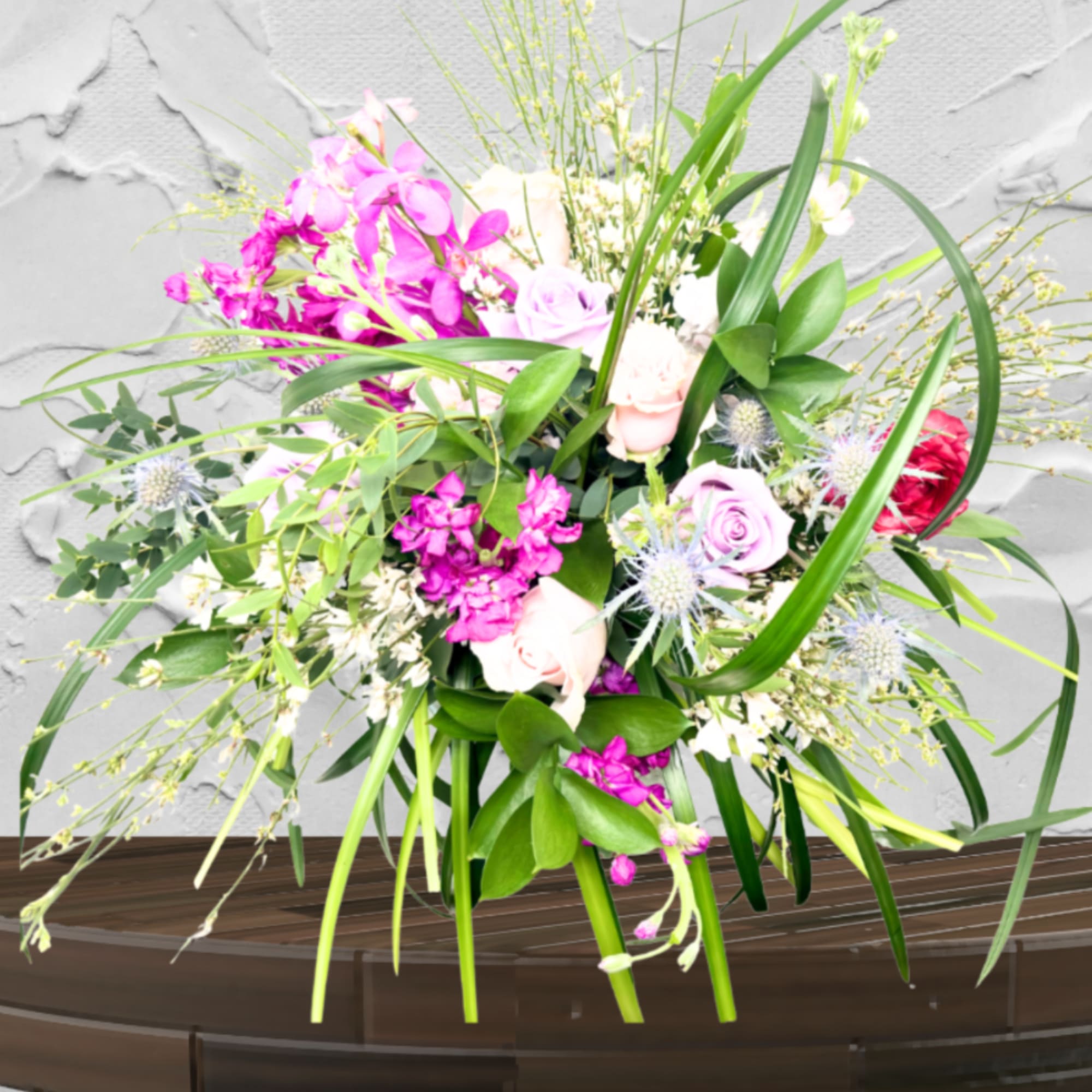 "Hand-crafted by accredited Master Florist Tricia Won (AIFD, EMC, IMF) using premium