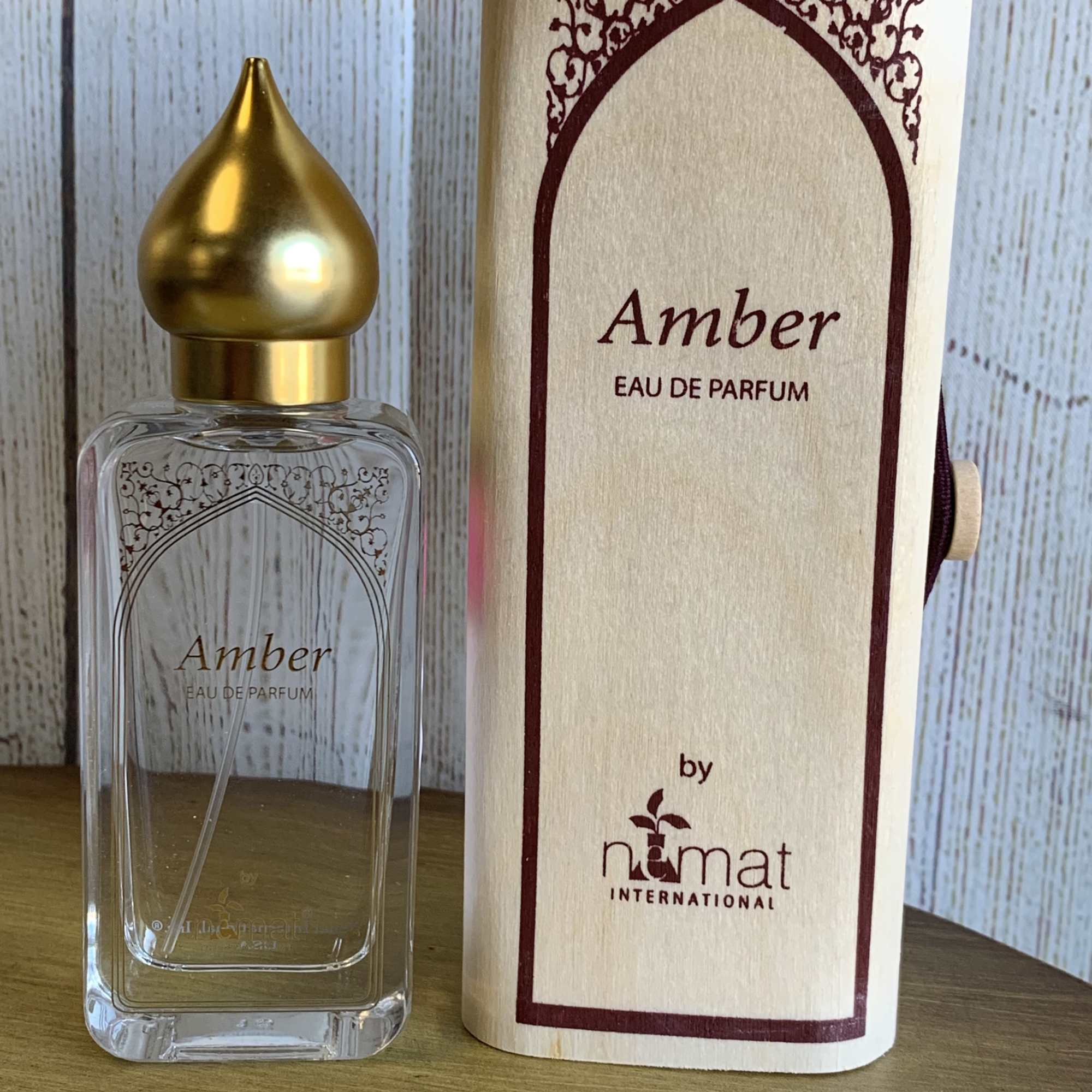 Amber eau de parfum bottle with matching box