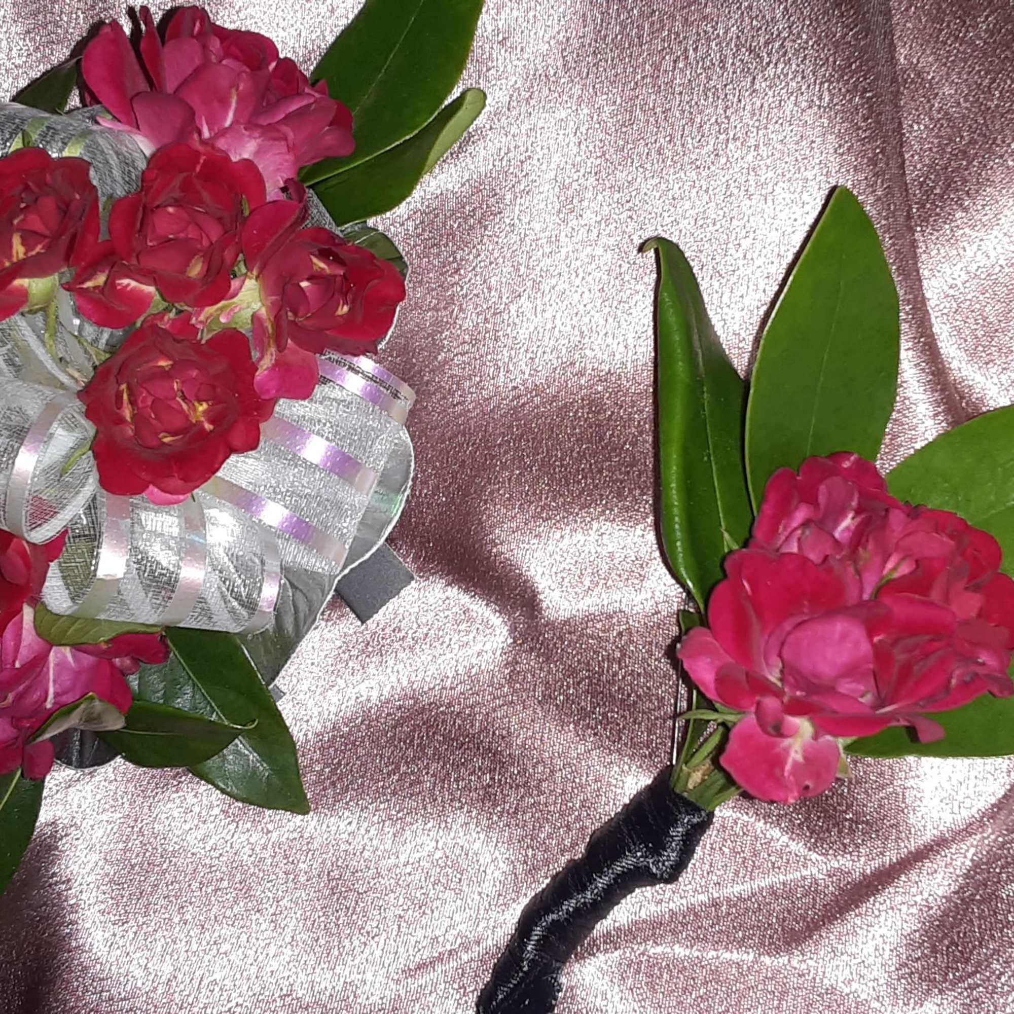 Pink floral bouquet and matching boutonniere with silver ribbon