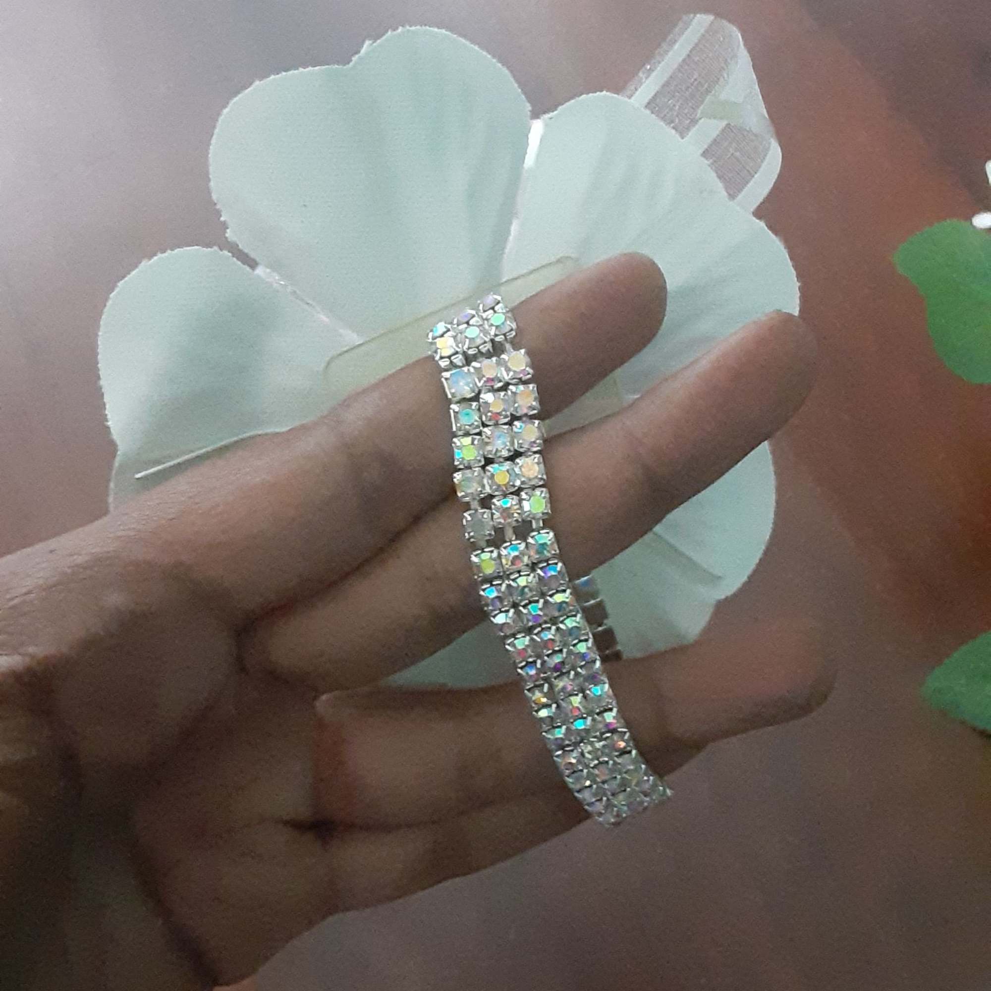 Iridescent pearl pull bow ribbon with silver base; secured on wrist by, photo 4 of 4