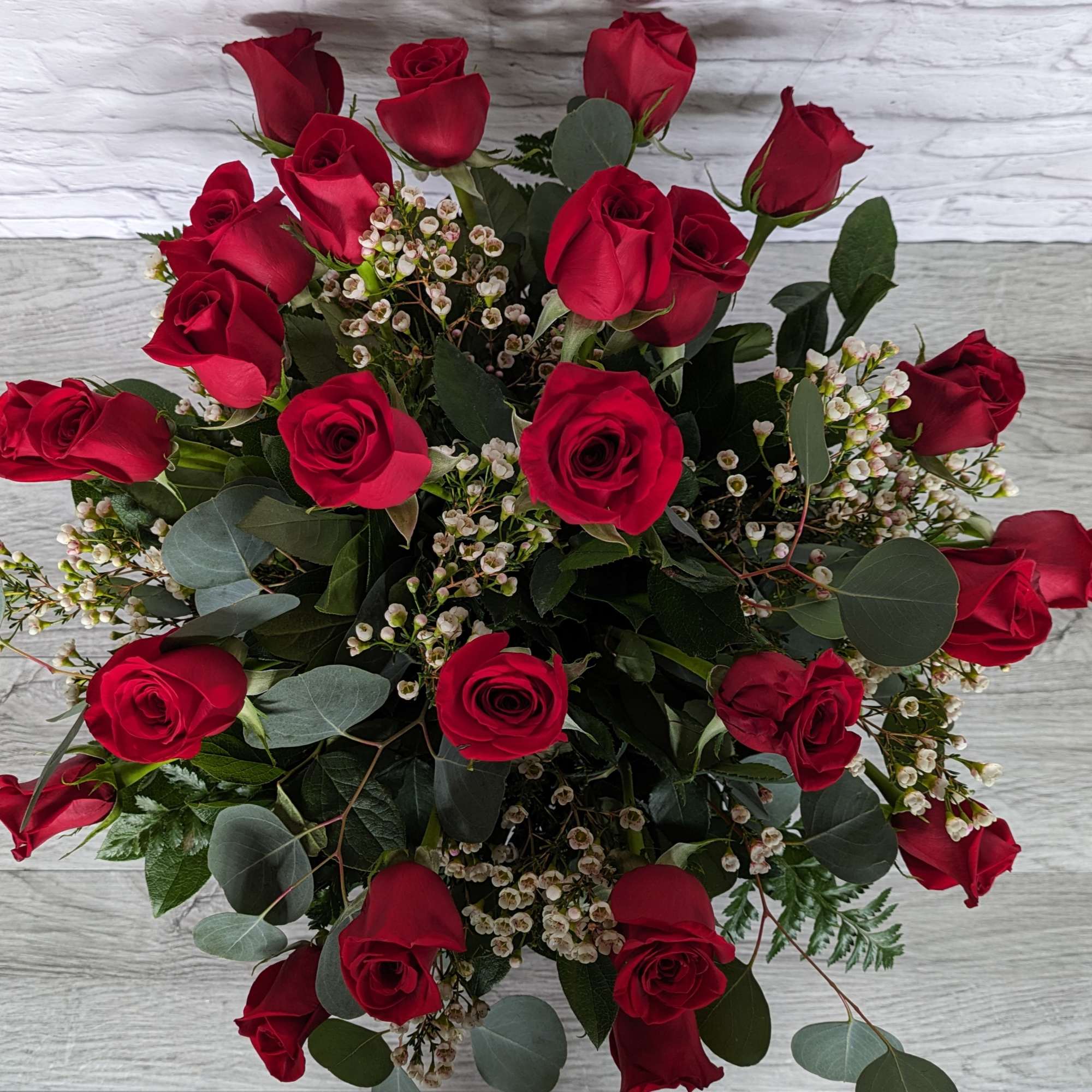 Bouquet of red roses with small white filler flowers