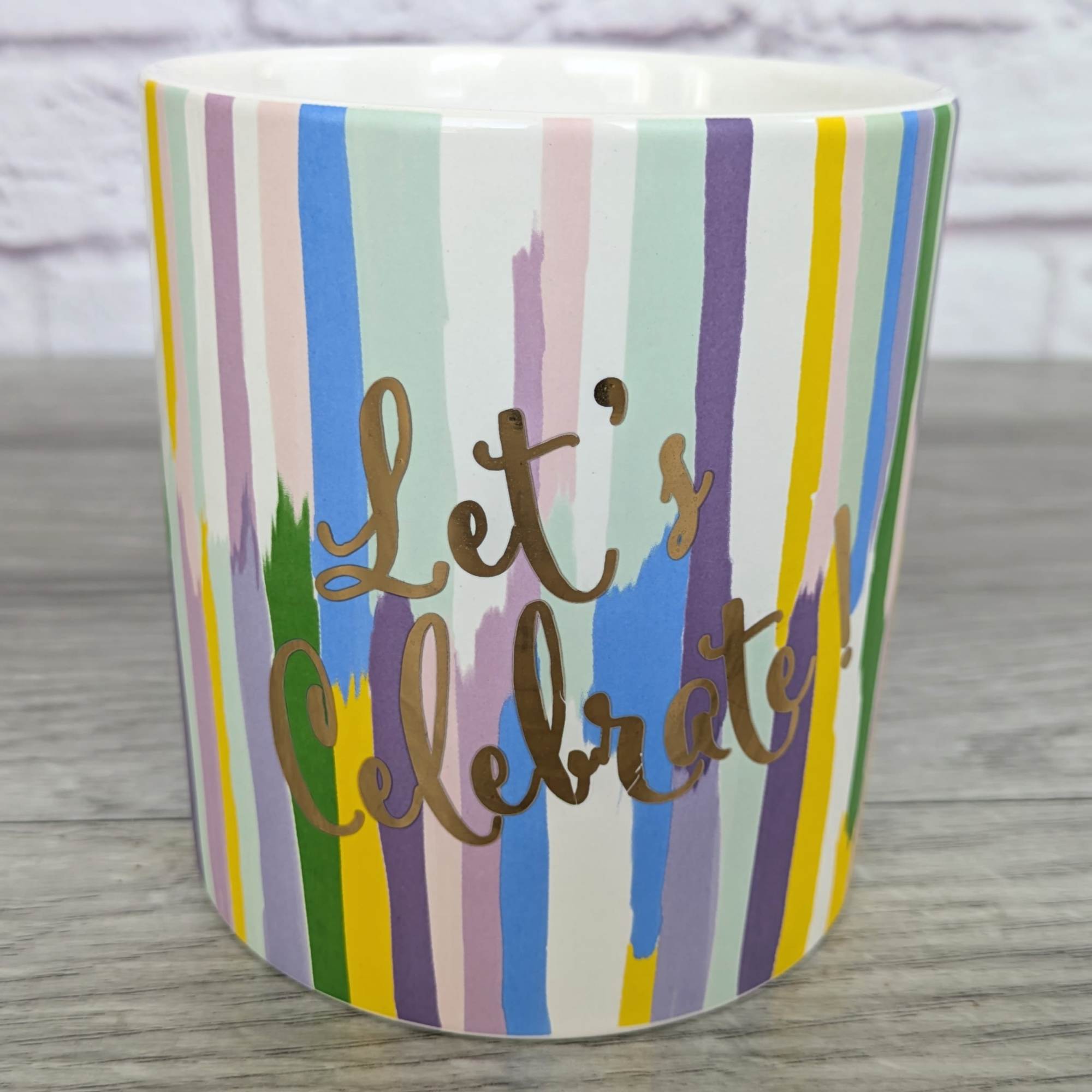 Striped ceramic mug with the words "Let's Celebrate!"