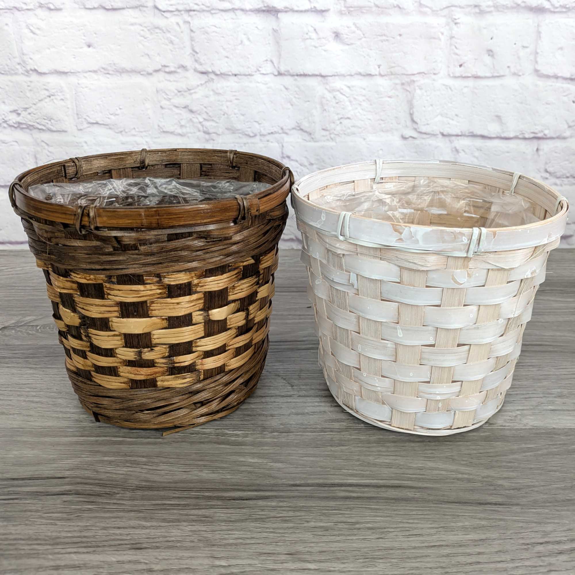Two woven basket planters, one brown and one white