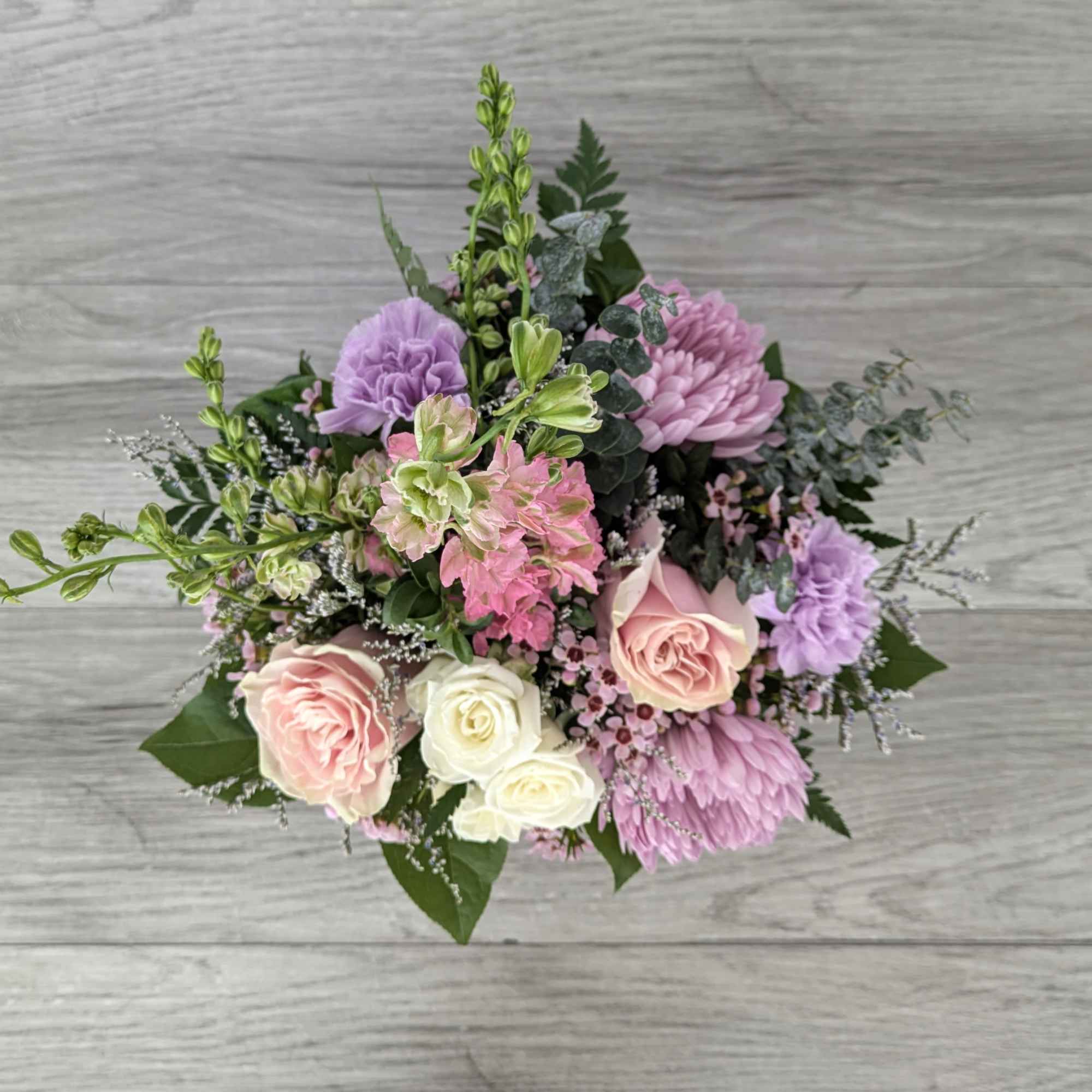 Bouquet of pink and lavender flowers with white roses