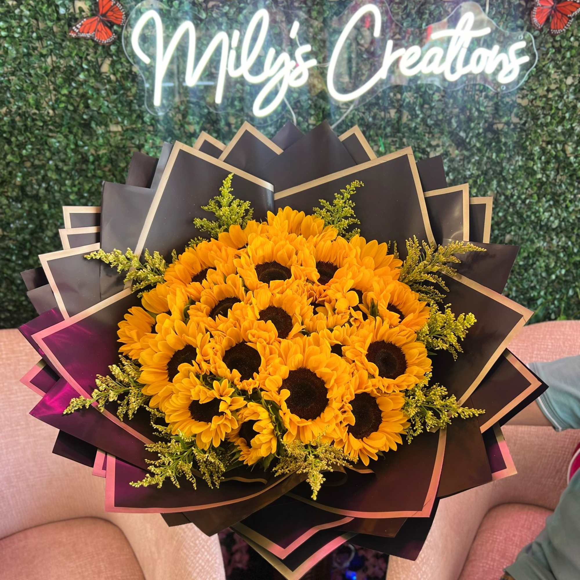Bouquet of yellow sunflowers wrapped in dark paper
