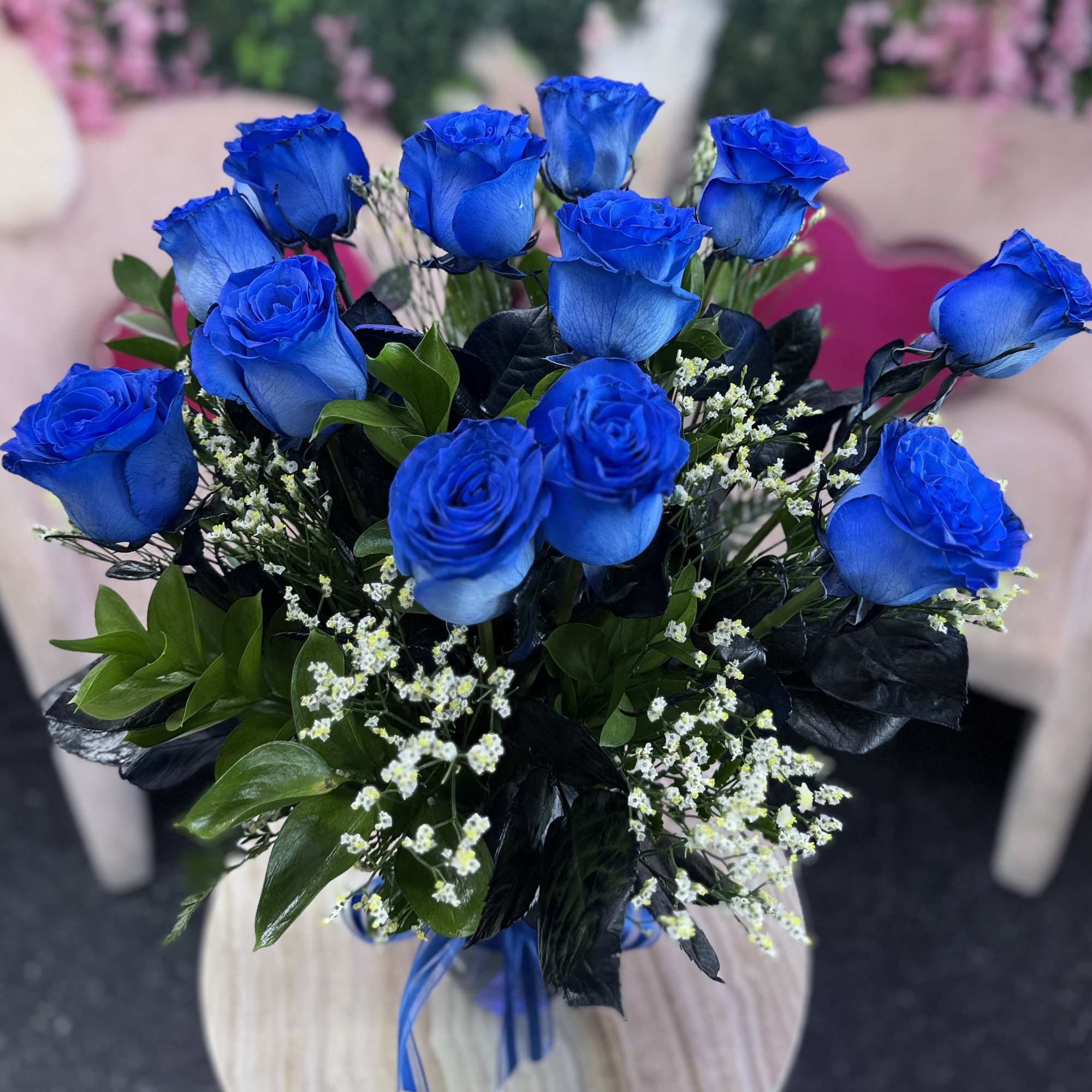 Bouquet of vivid blue roses with small white filler flowers, photo 2 of 4