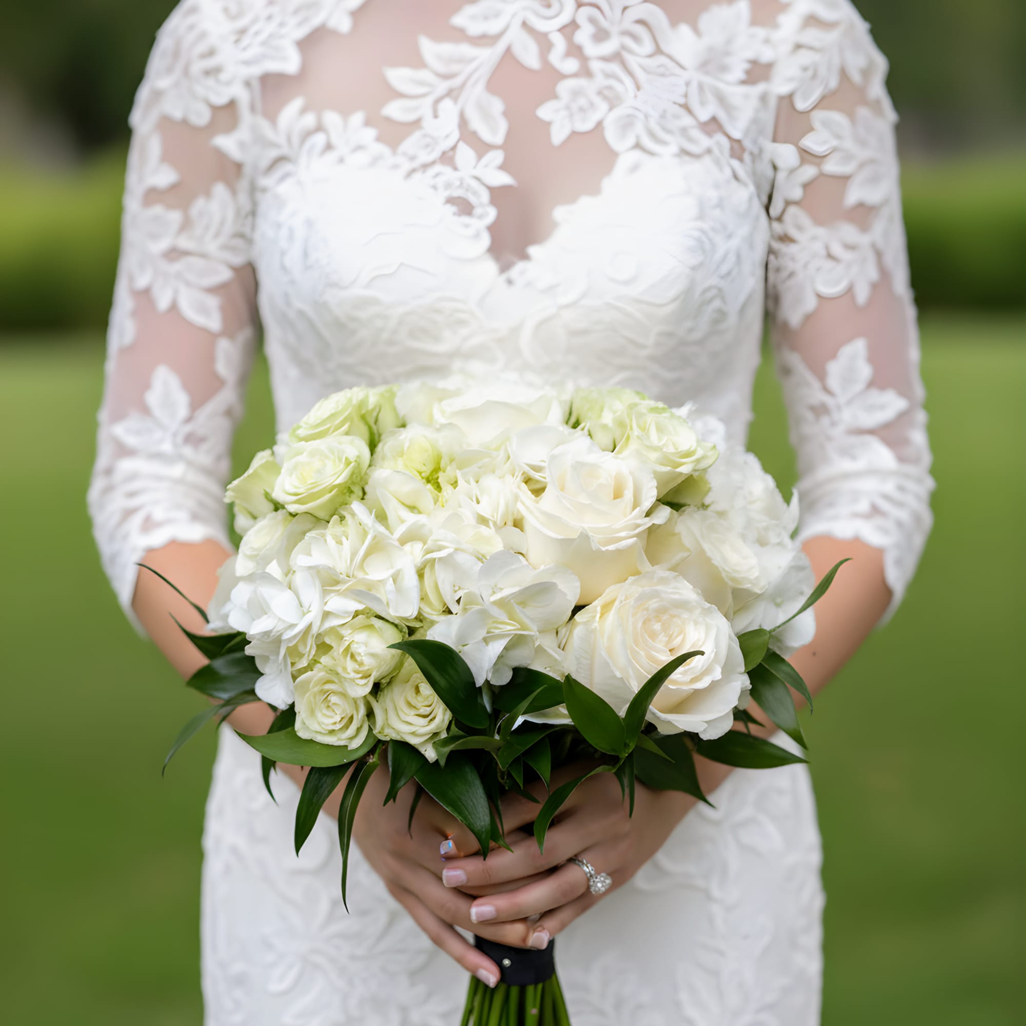 Bride holding a white rose and hydrangea bouquet