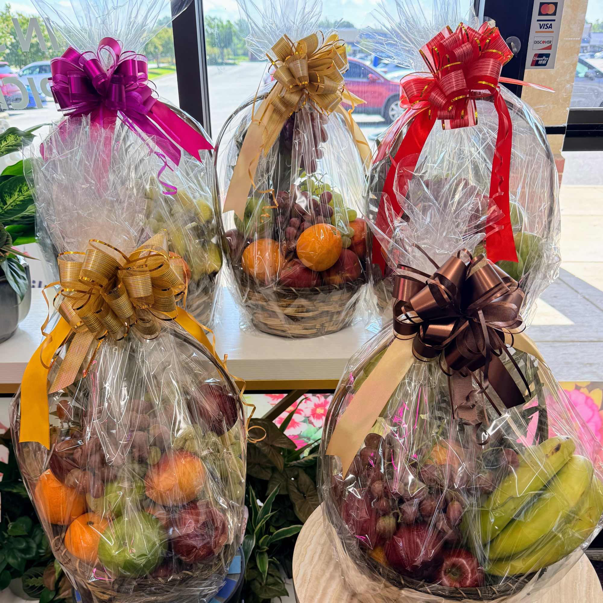 Wrapped fruit baskets with large decorative bows
