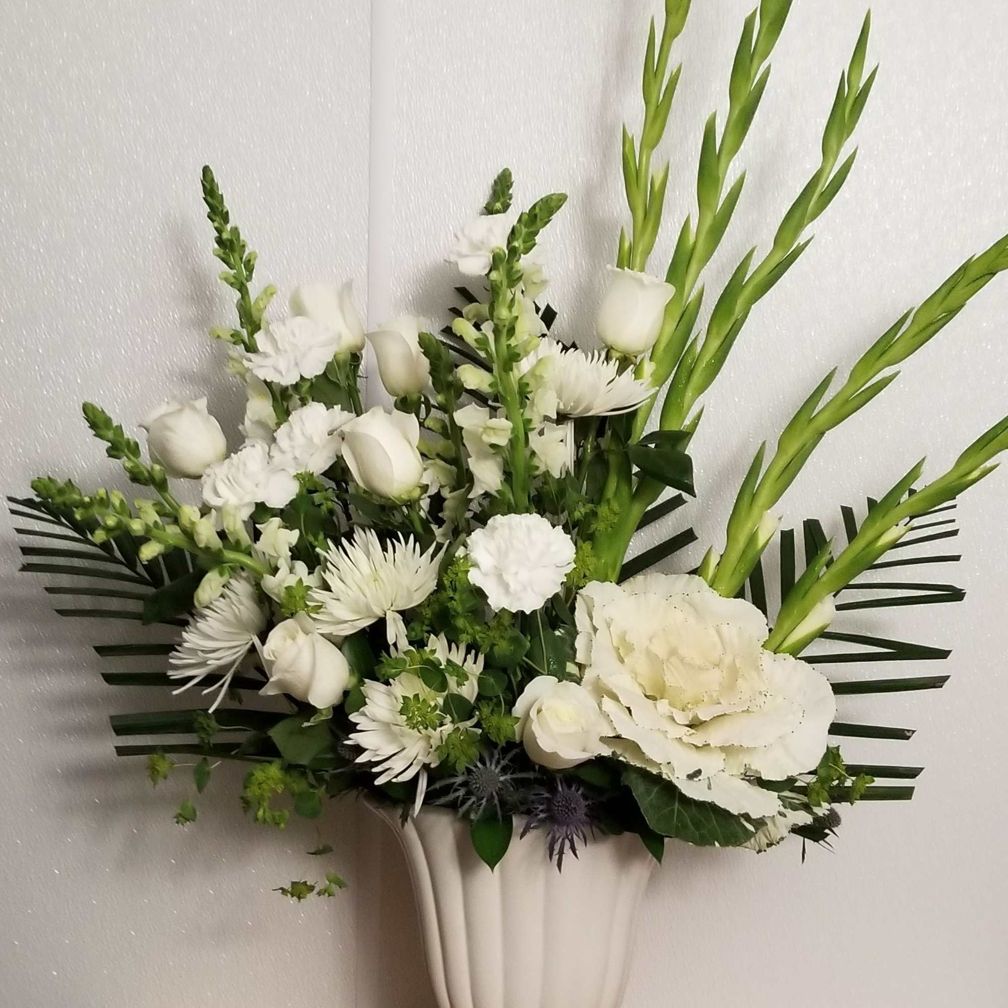 A large white arrangement is suitable for a memorial service to honor
