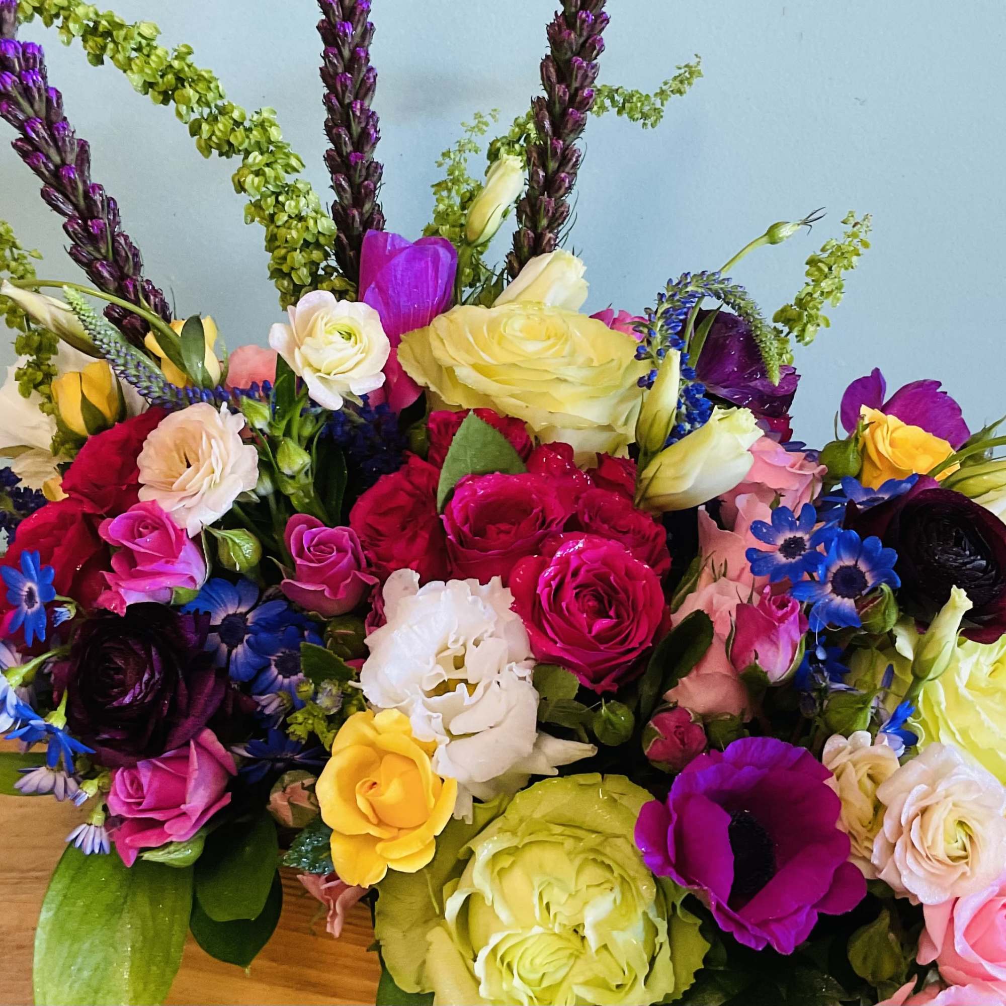 Bursting with color and joyful texture, this low rectangular arrangement is a