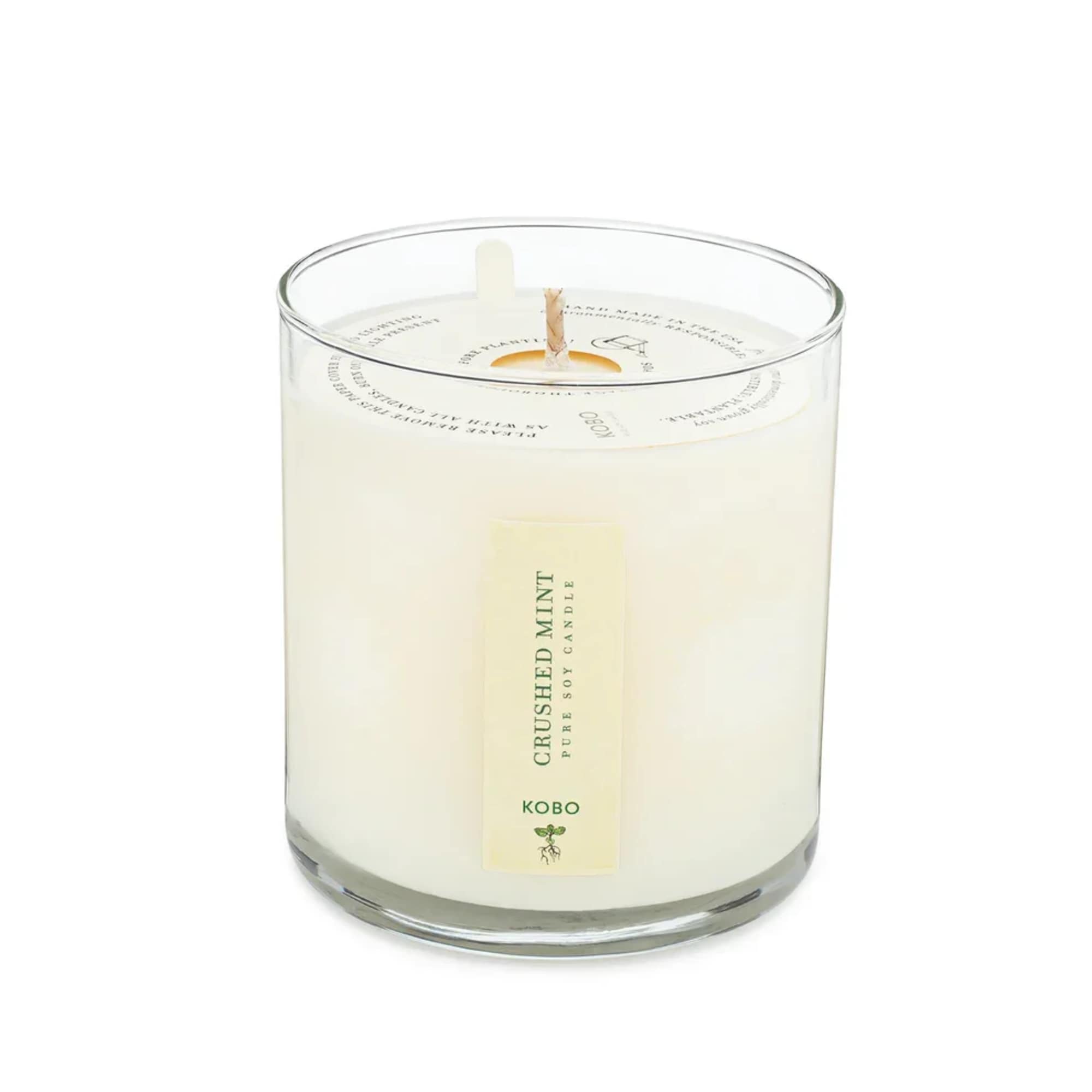 White candle in a clear glass tumbler