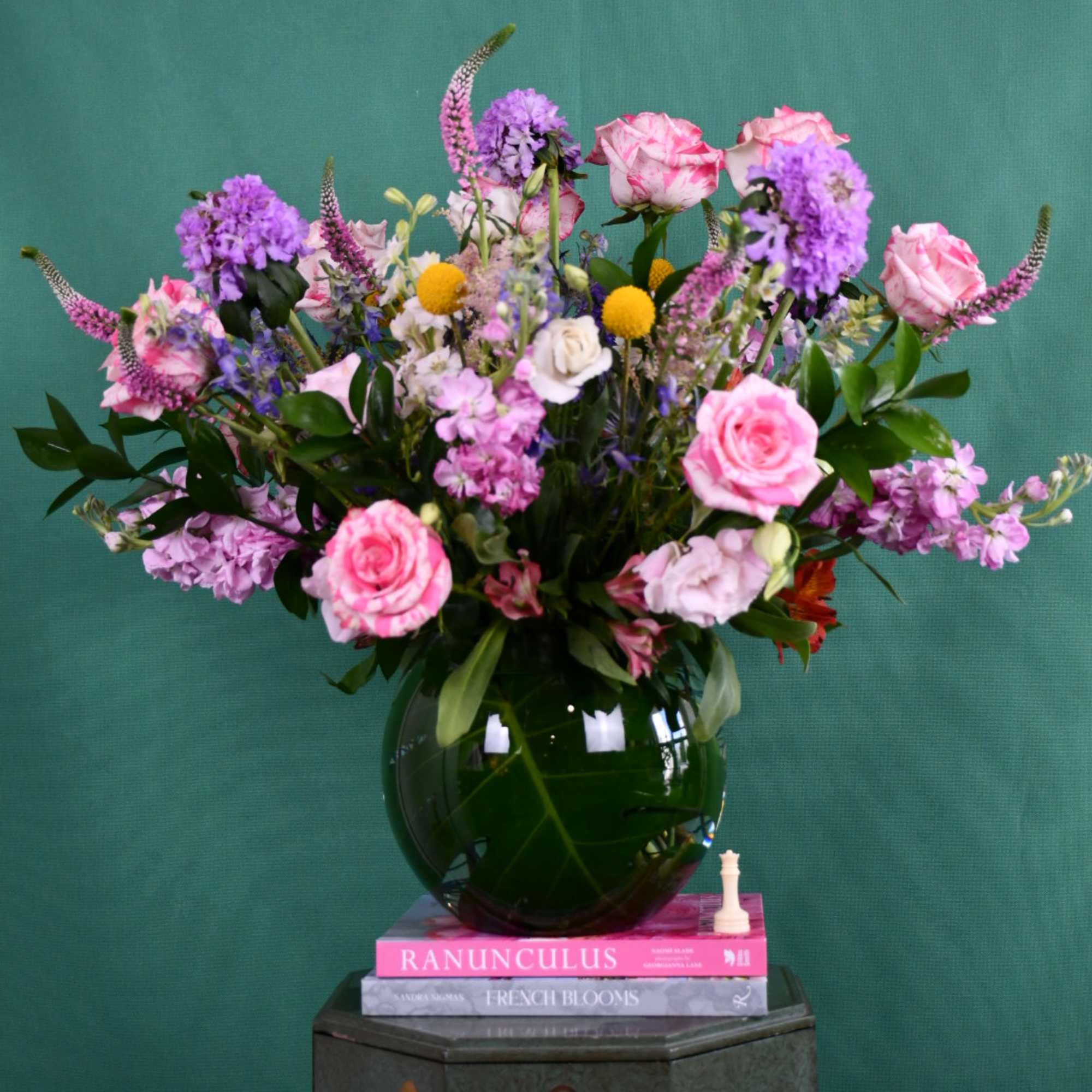 Pink and purple mixed bouquet in a round glass vase