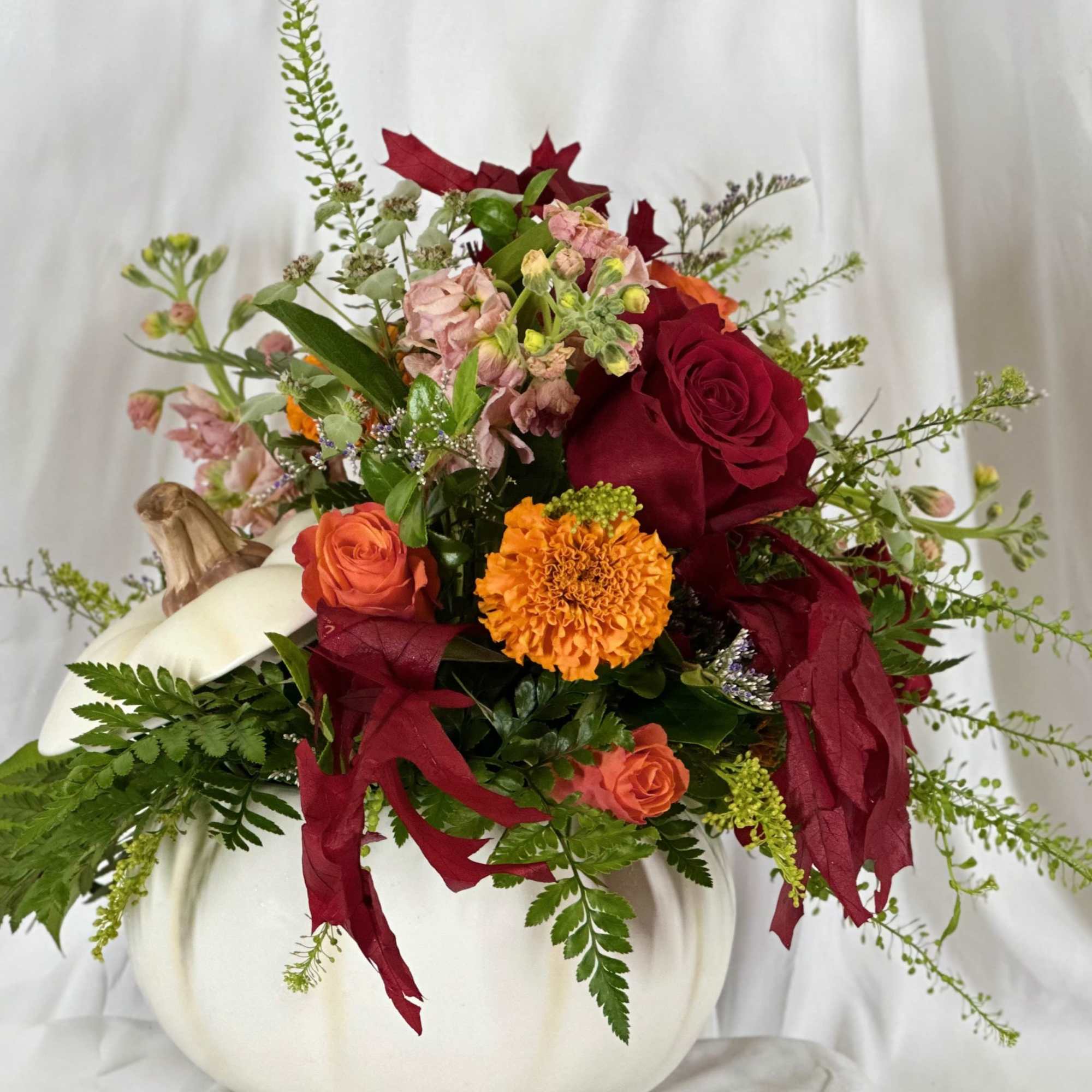 Fun and festive, this Fall flower arrangement features Autumn hues of stock
