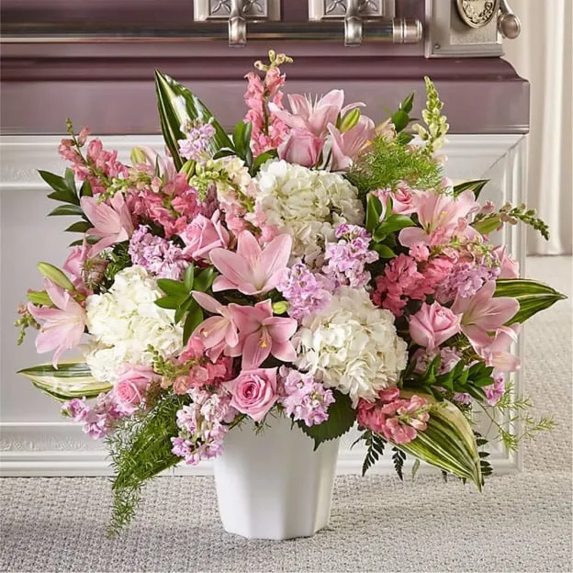 Pink and white floral arrangement in a white vase