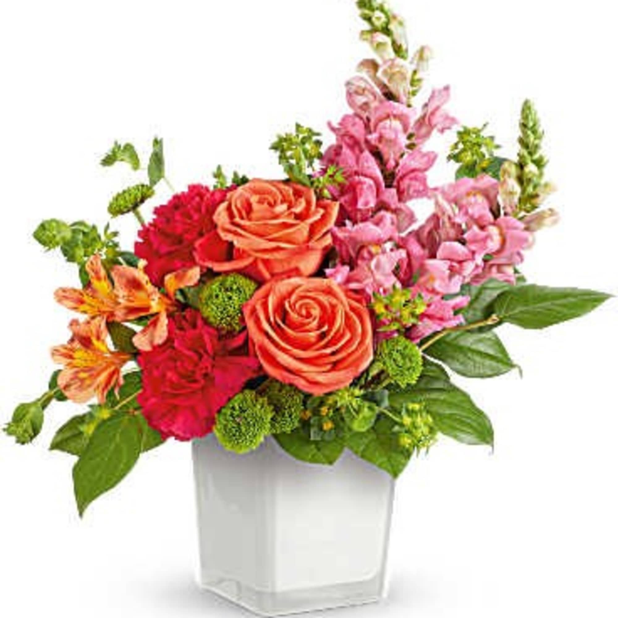 Colorful mixed flower arrangement in a white square vase