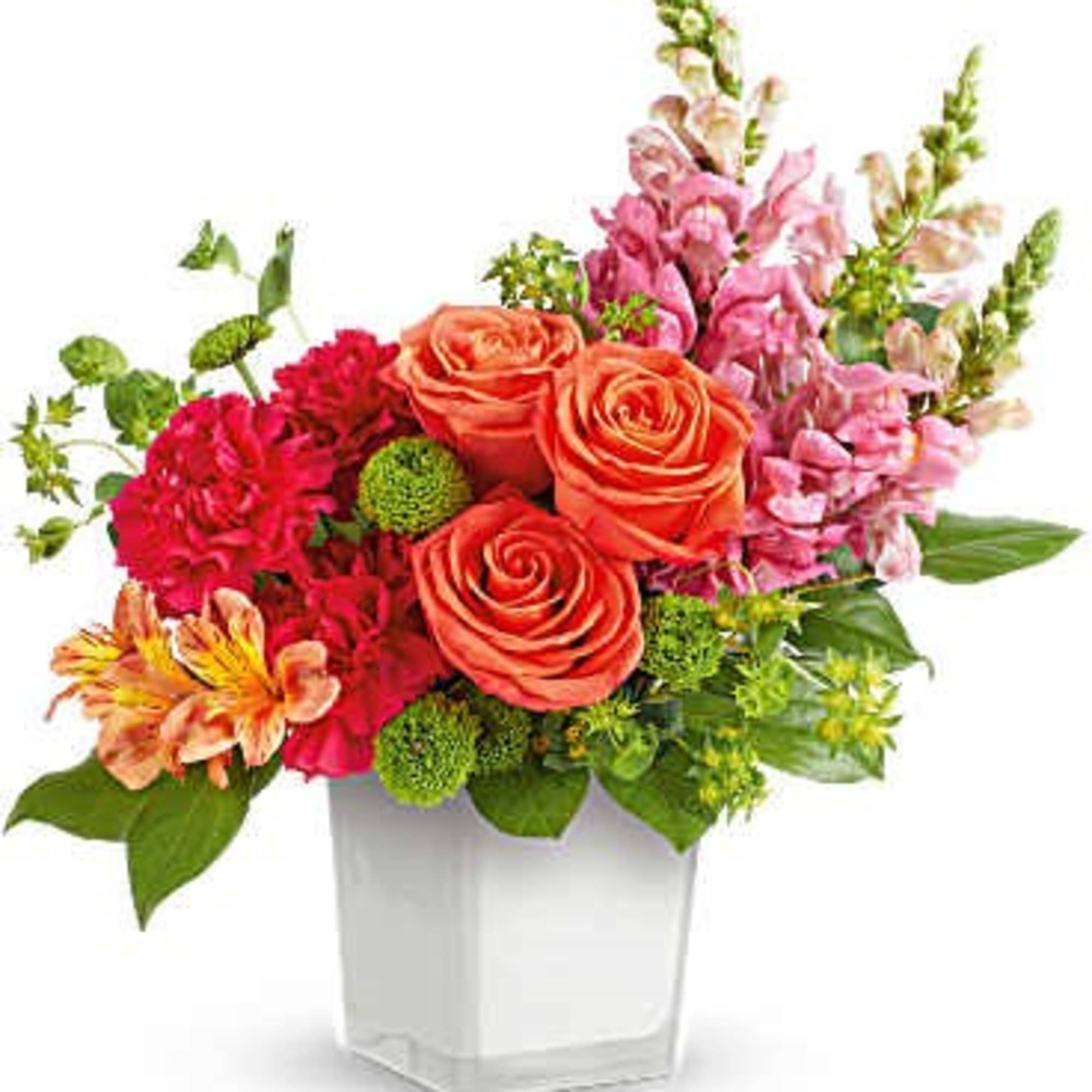 Mixed bouquet of orange roses, pink snapdragons, and red carnations in a white vase