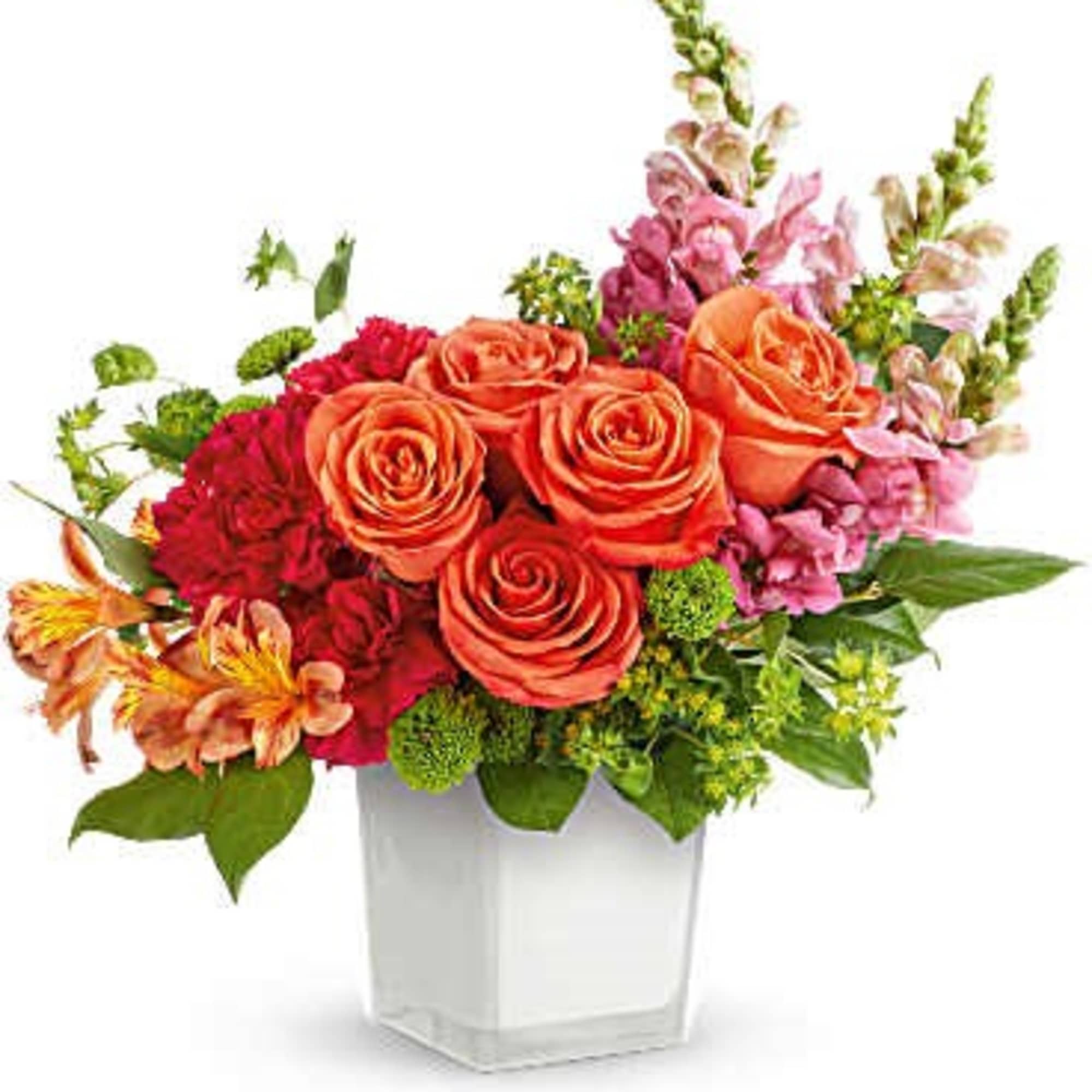 Orange roses and pink flowers arranged in a clear square vase