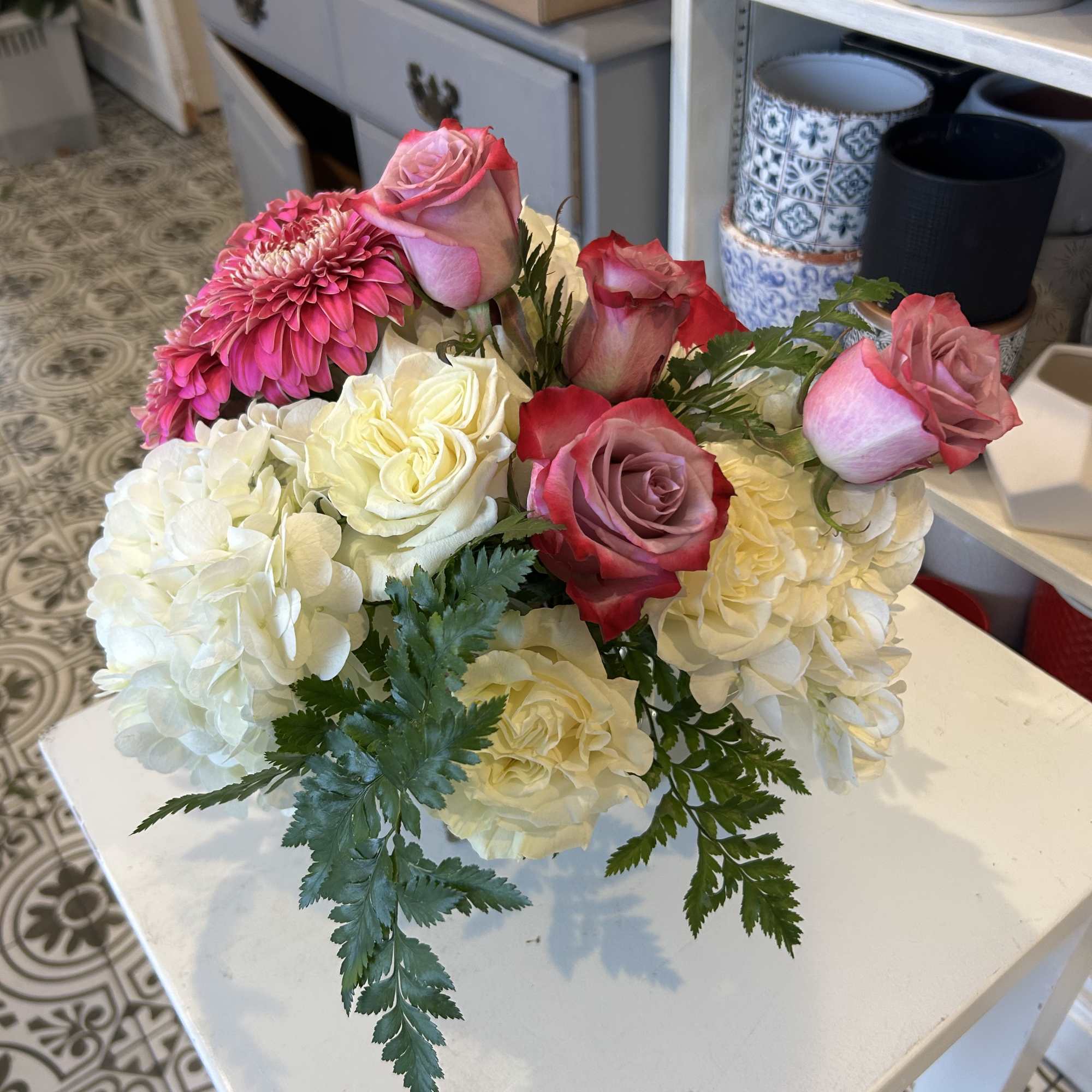 Bouquet of pink roses, white hydrangeas, and a pink chrysanthemum