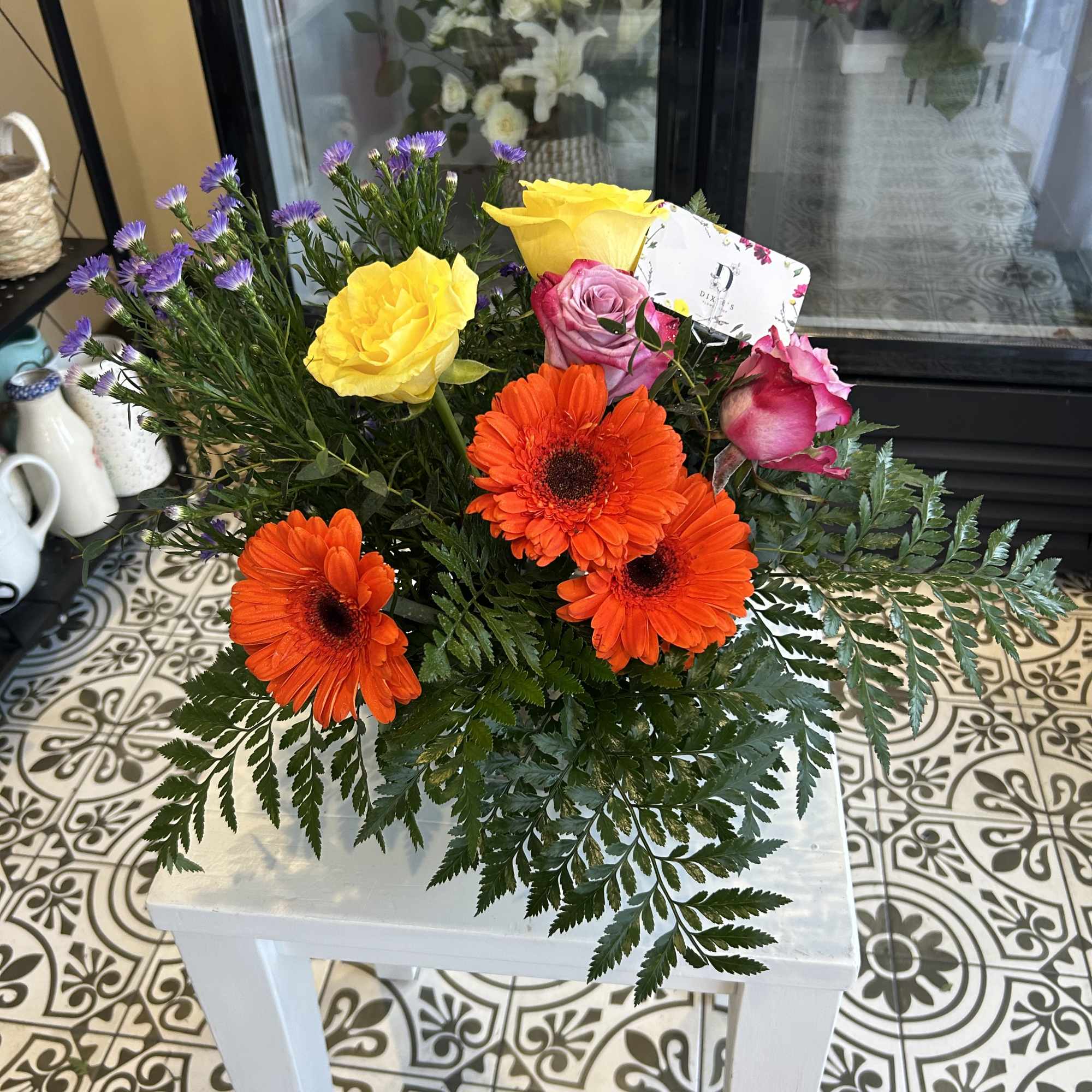 Bouquet of orange gerbera daisies and pink and yellow roses