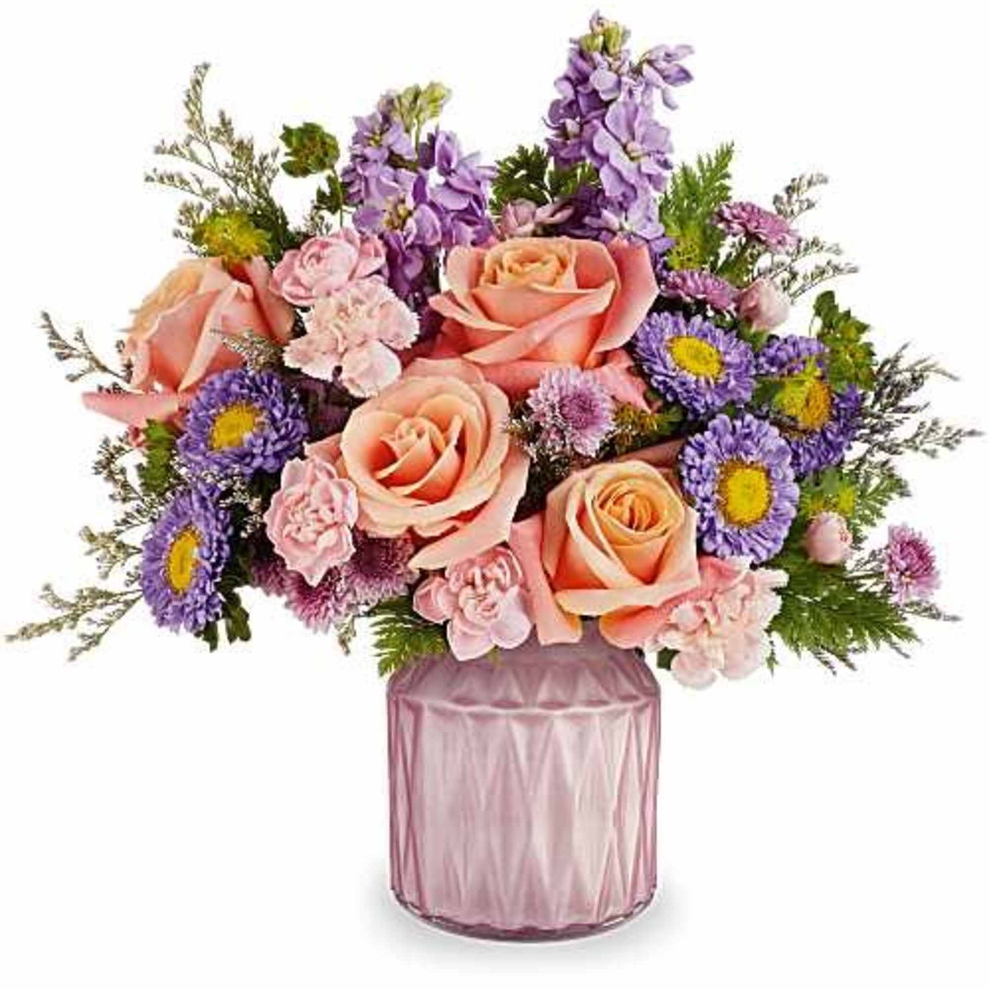 Bouquet of peach roses and purple flowers in a pink glass vase