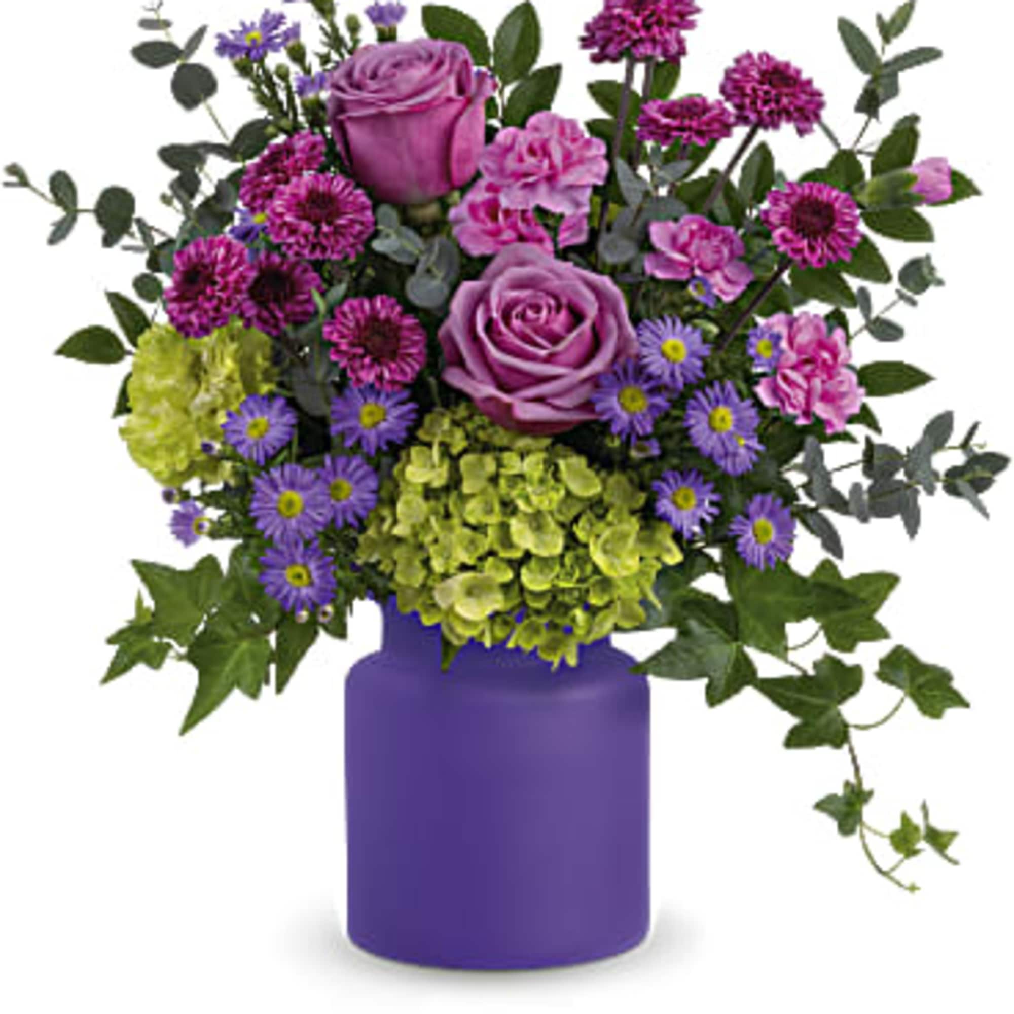 Purple and pink flower arrangement in a purple vase