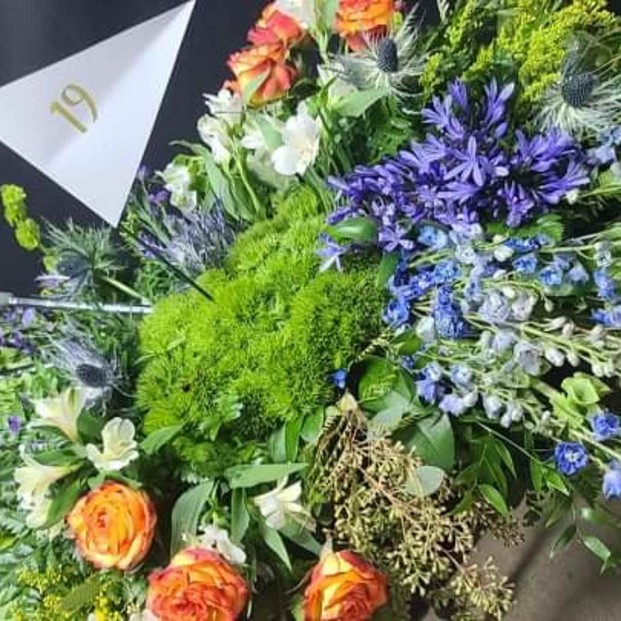Large mixed bouquet with orange roses and purple flowers