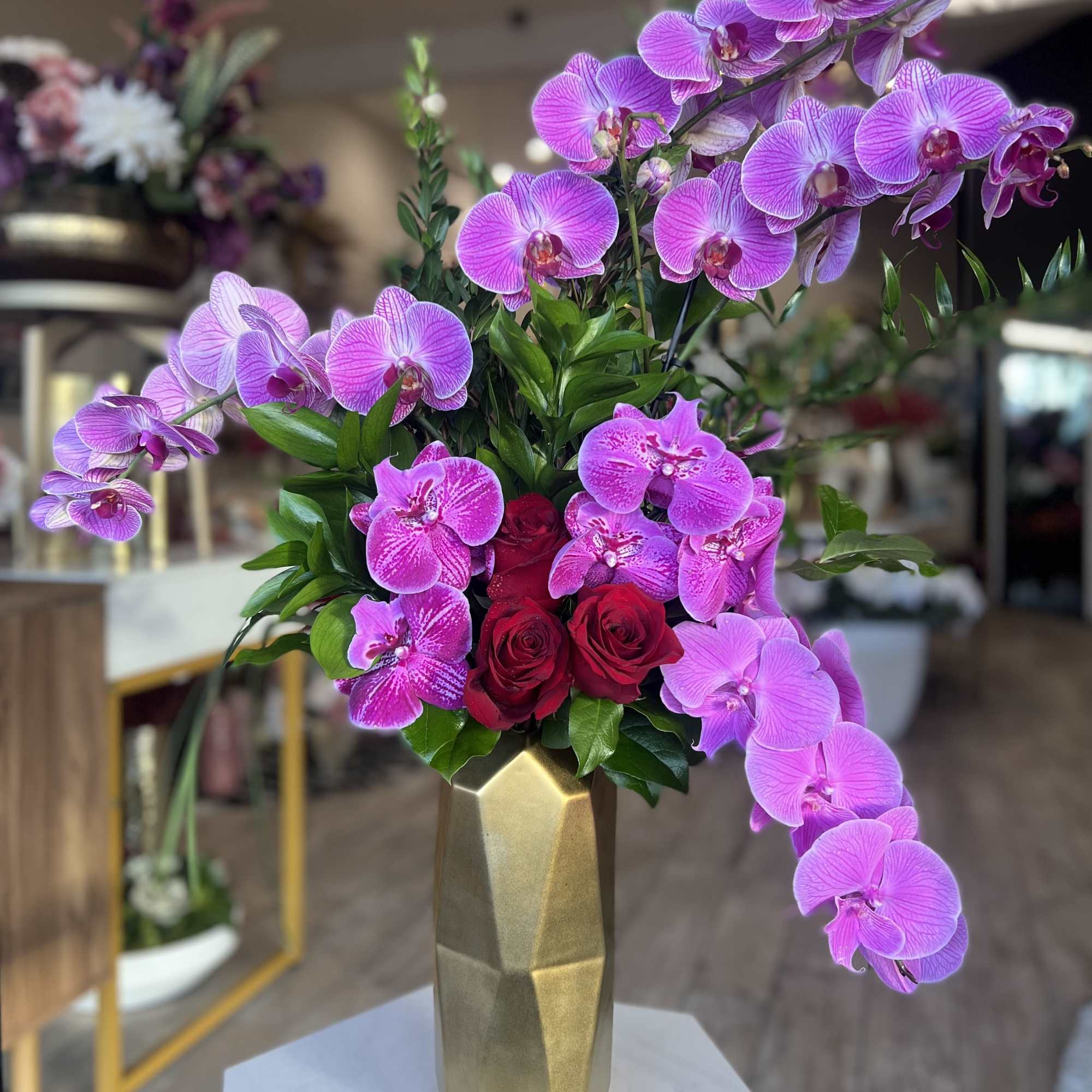 Pink orchids and red roses in a gold vase, photo 2 of 2