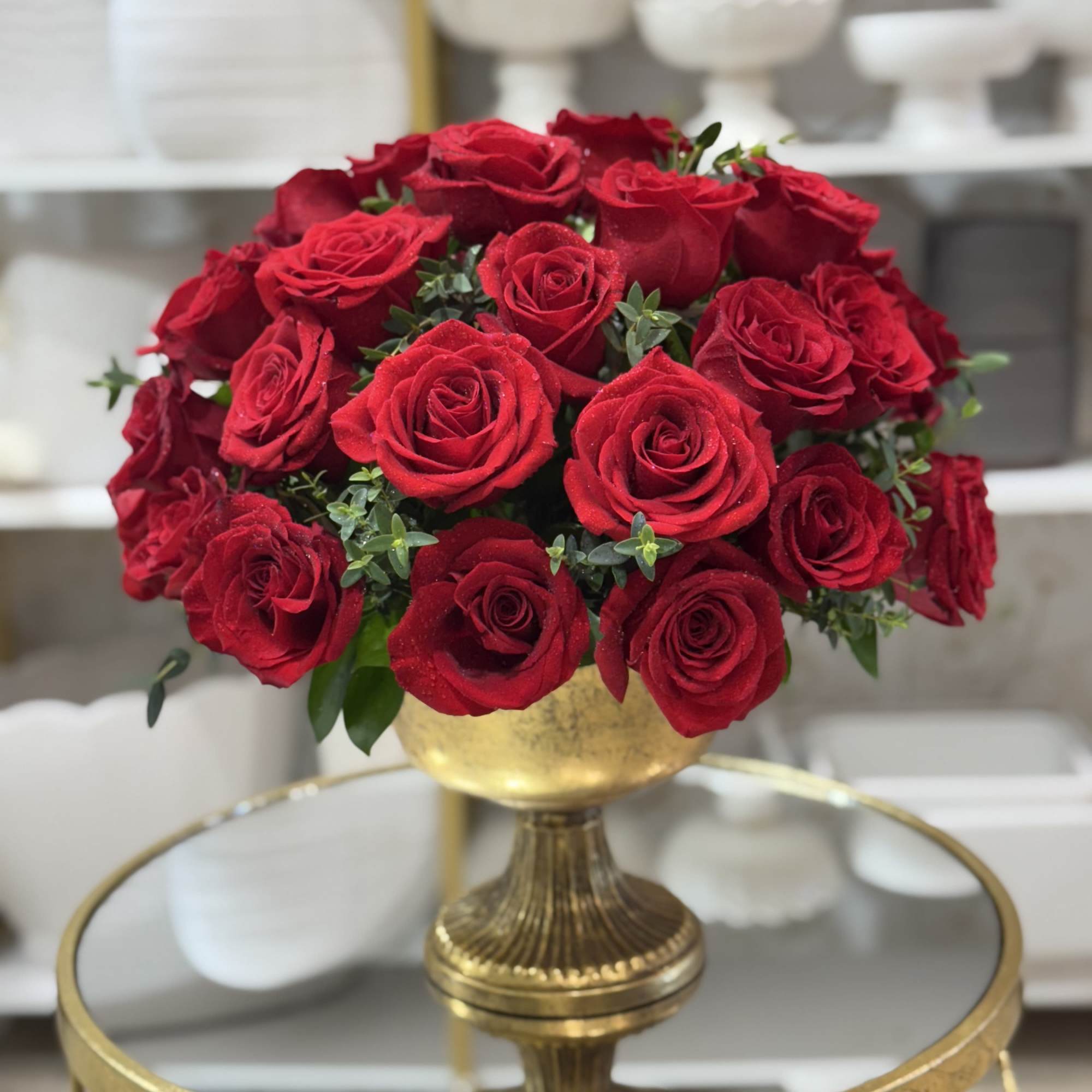 Red rose bouquet in a gold pedestal vase